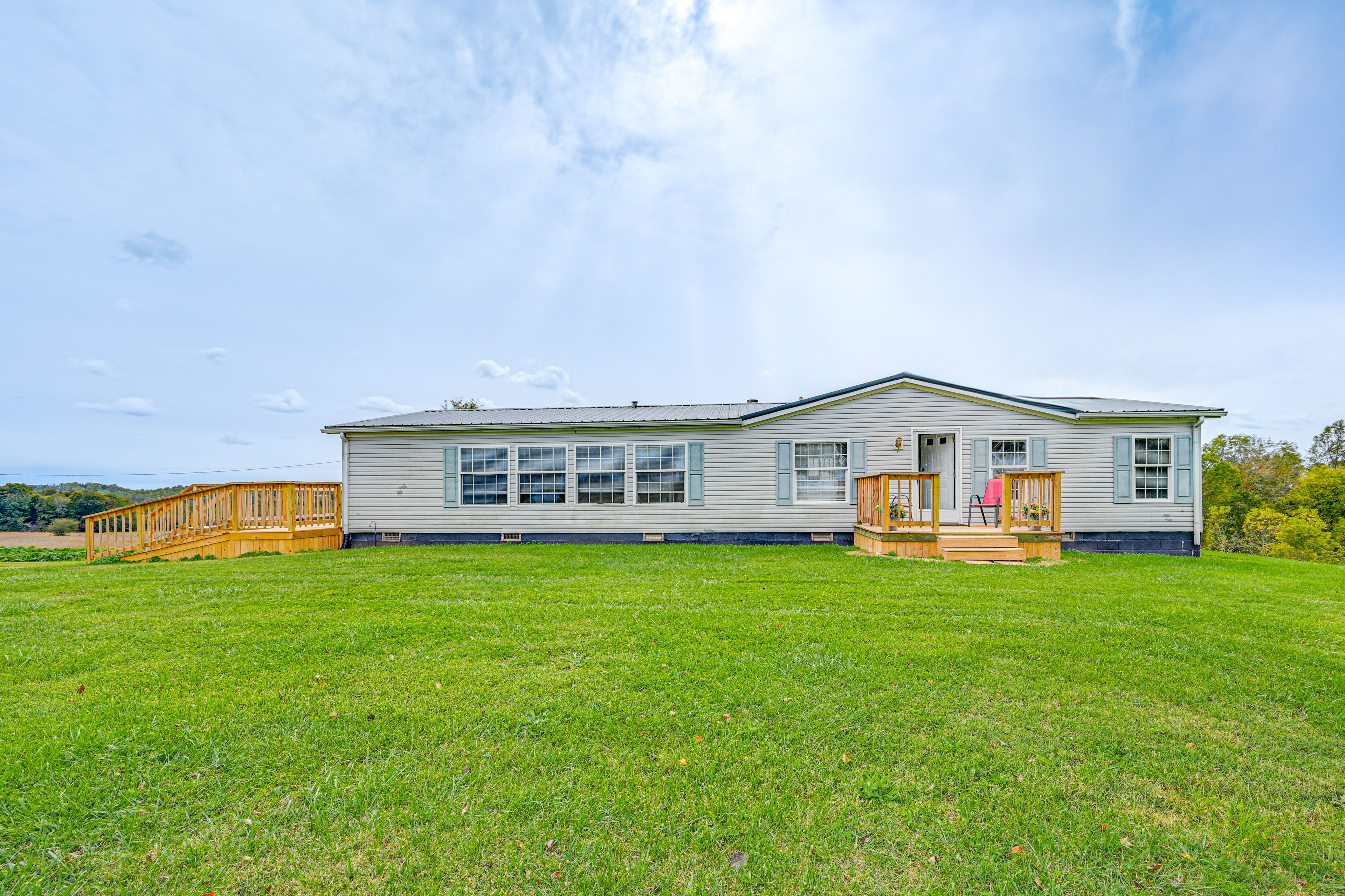 Property Exterior | Spacious Yard | Furnished Deck & Porch