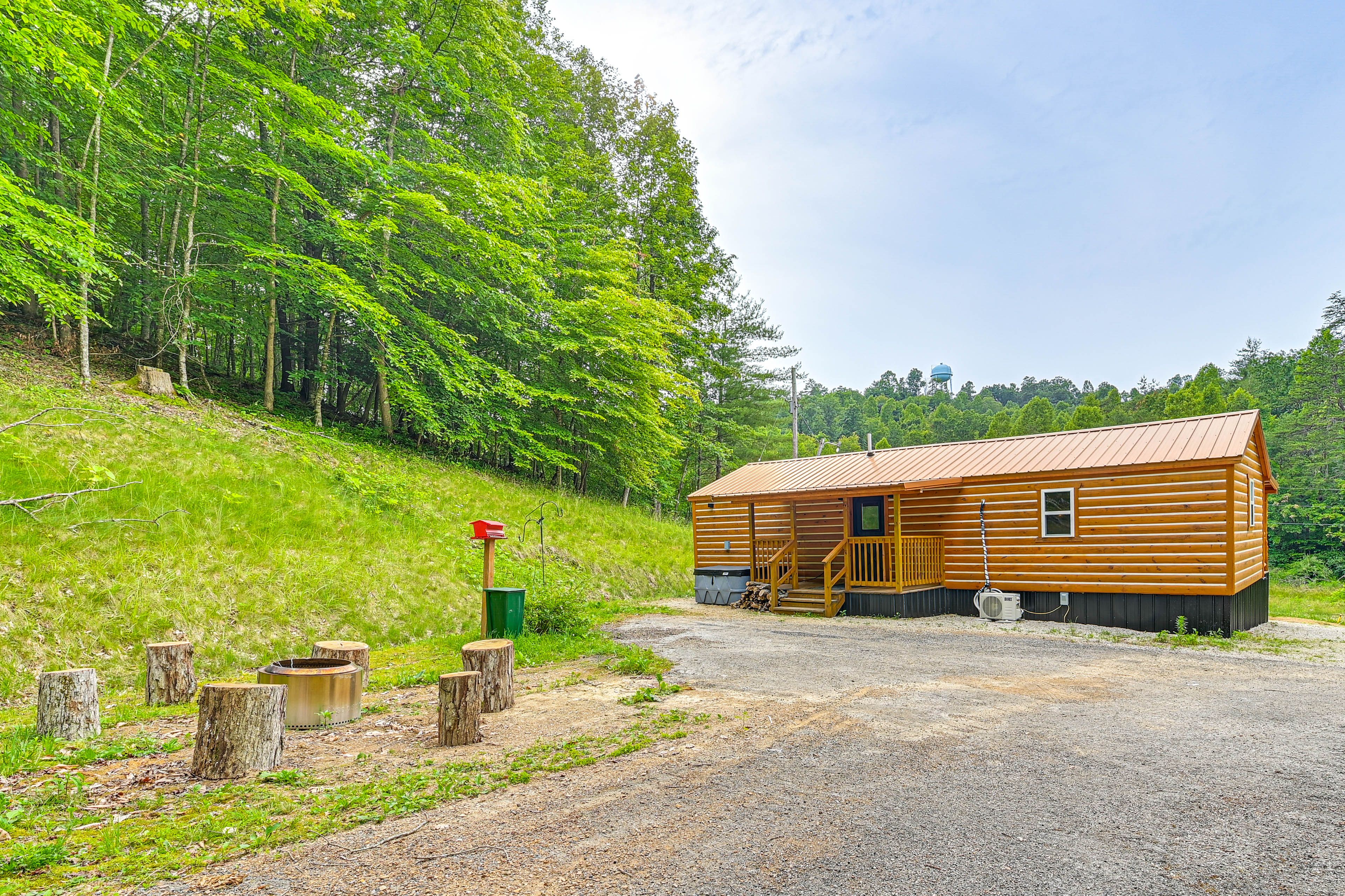 Cabin Exterior | Fire Pit | Wooded Surroundings