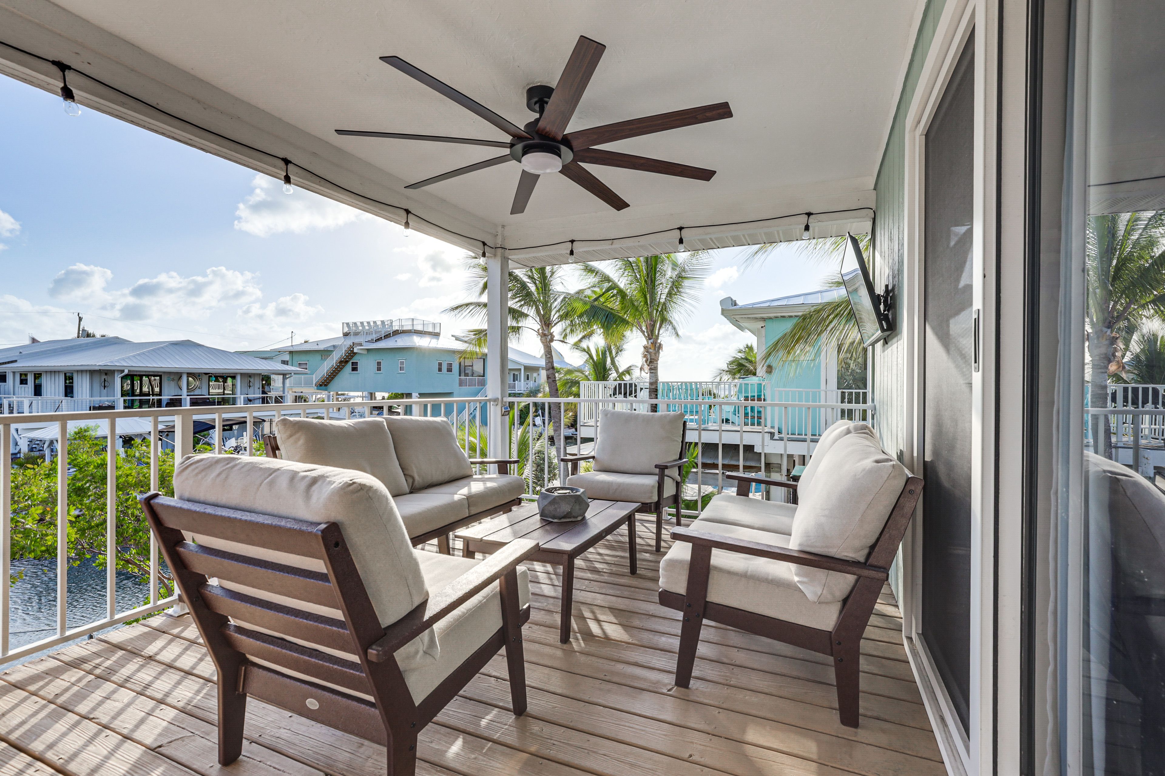 House Exterior | Deck w/ Seating | Smart TV | Canal Views