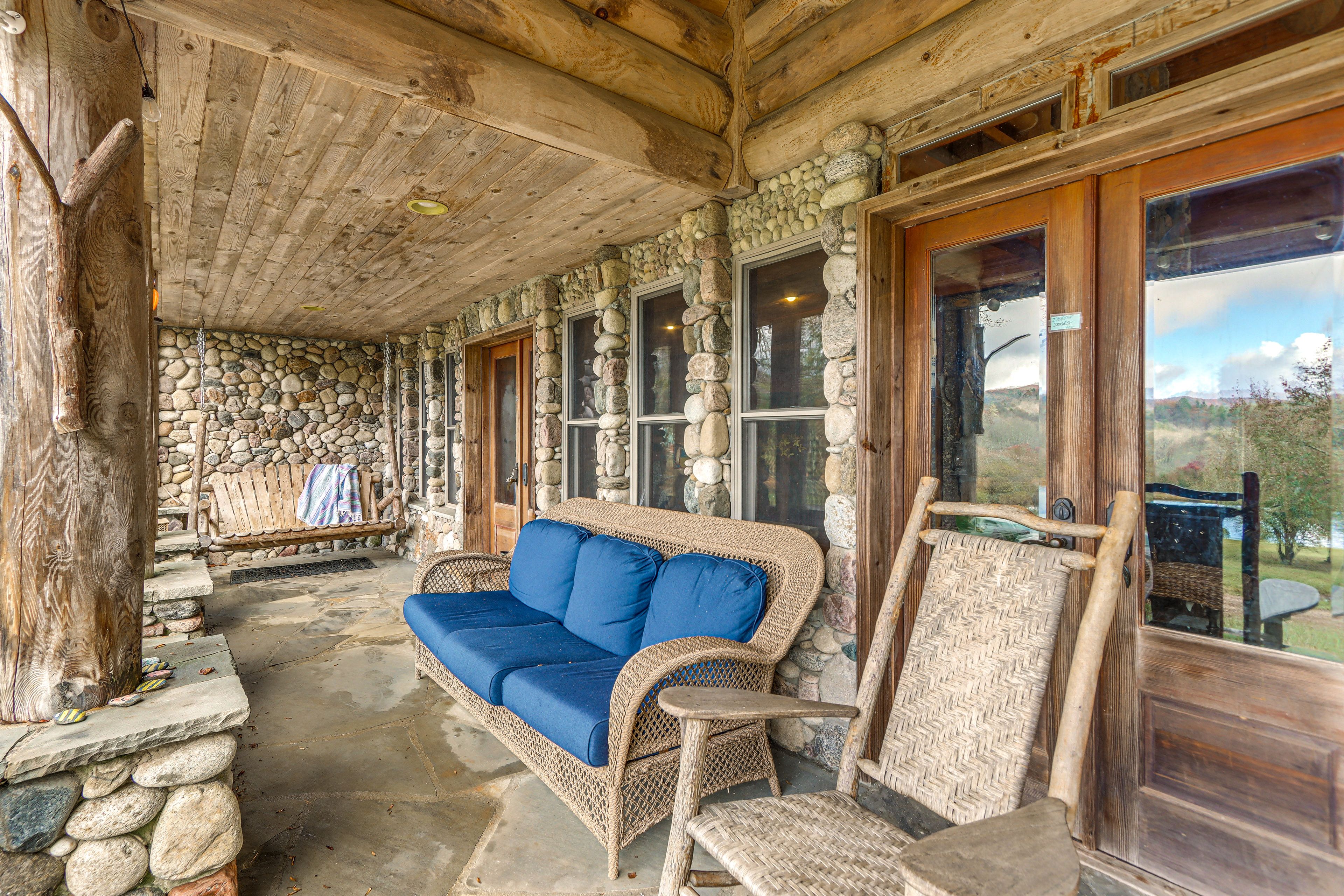 Covered Patio | Swing & Seating | Lake & Mountain Views | Outdoor Fireplace