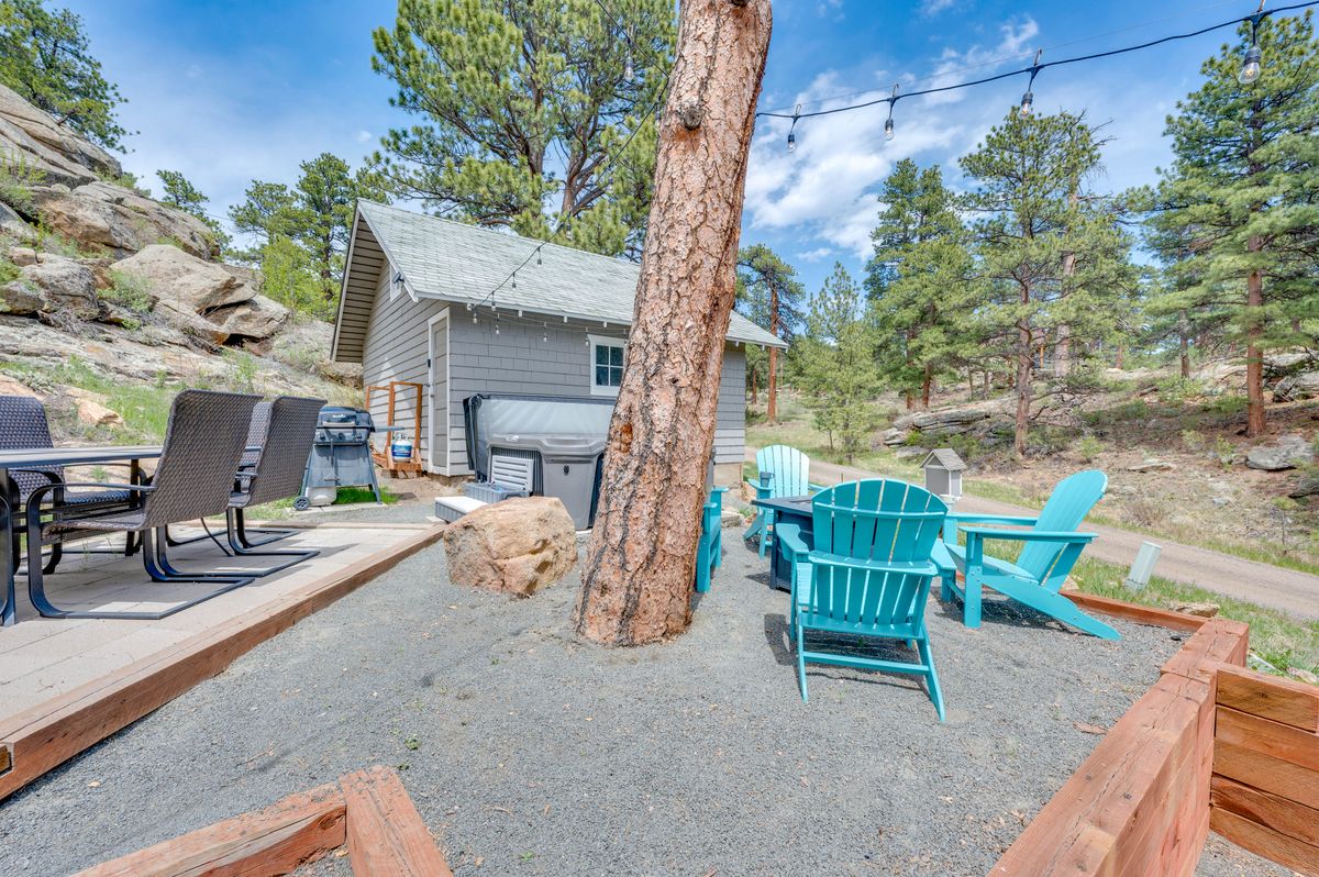 Fire pit, hot tub and Adirondack chairs at dusk