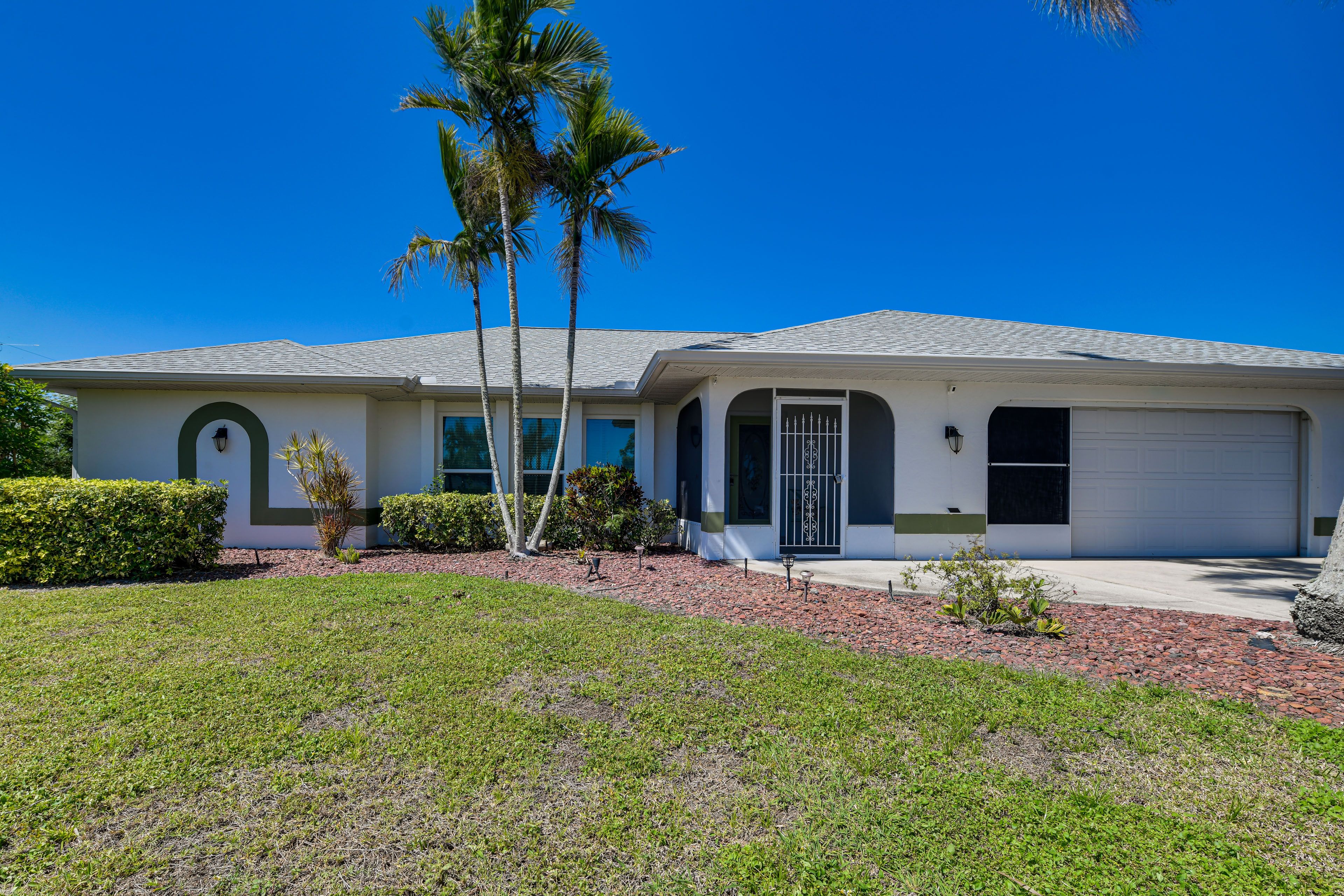 Property Exterior | Screened-In Lanai w/ Pool & Covered Patio