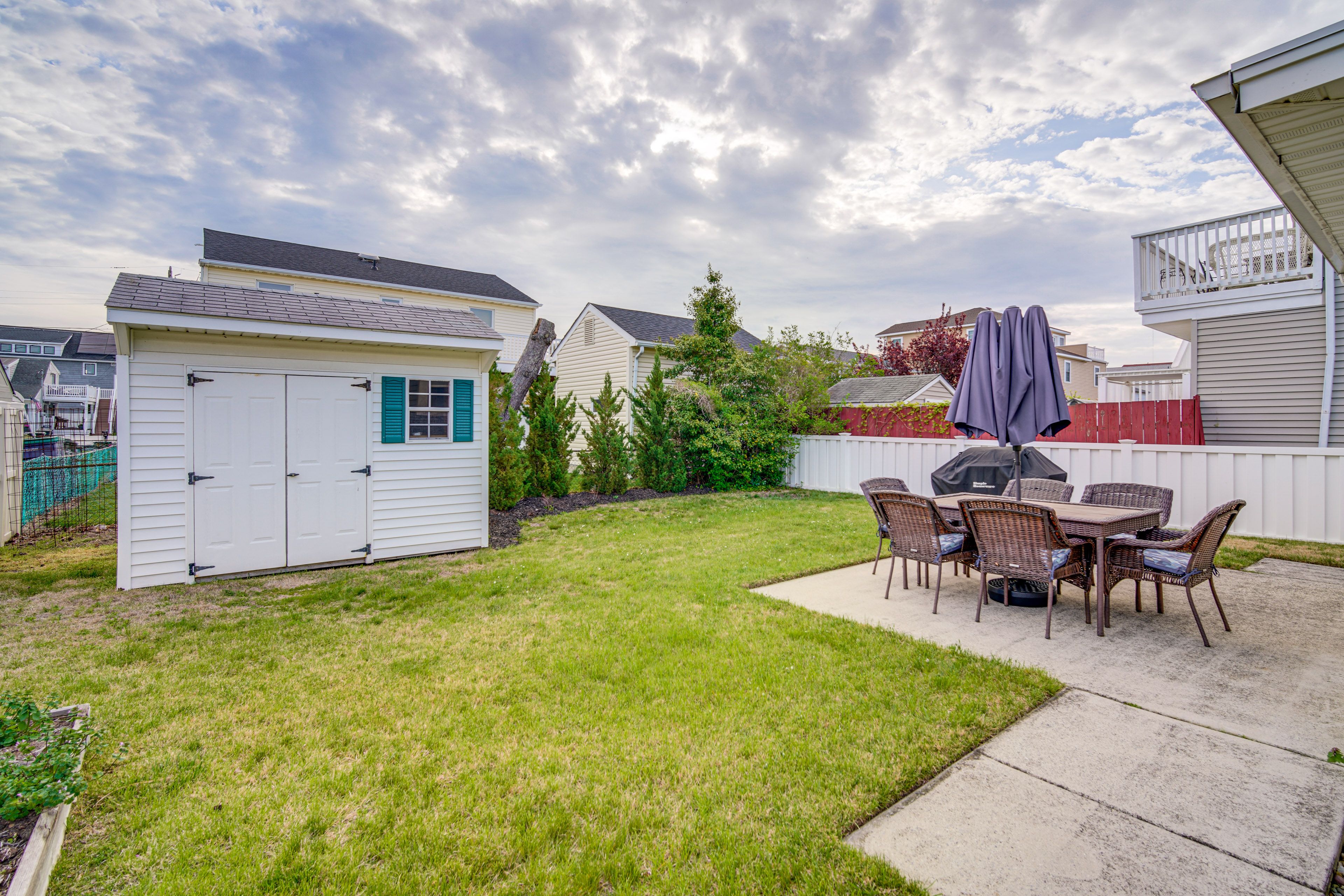 House Exterior | Patio | Dining Area w/ Umbrella | Gas Grill | Fenced Backyard