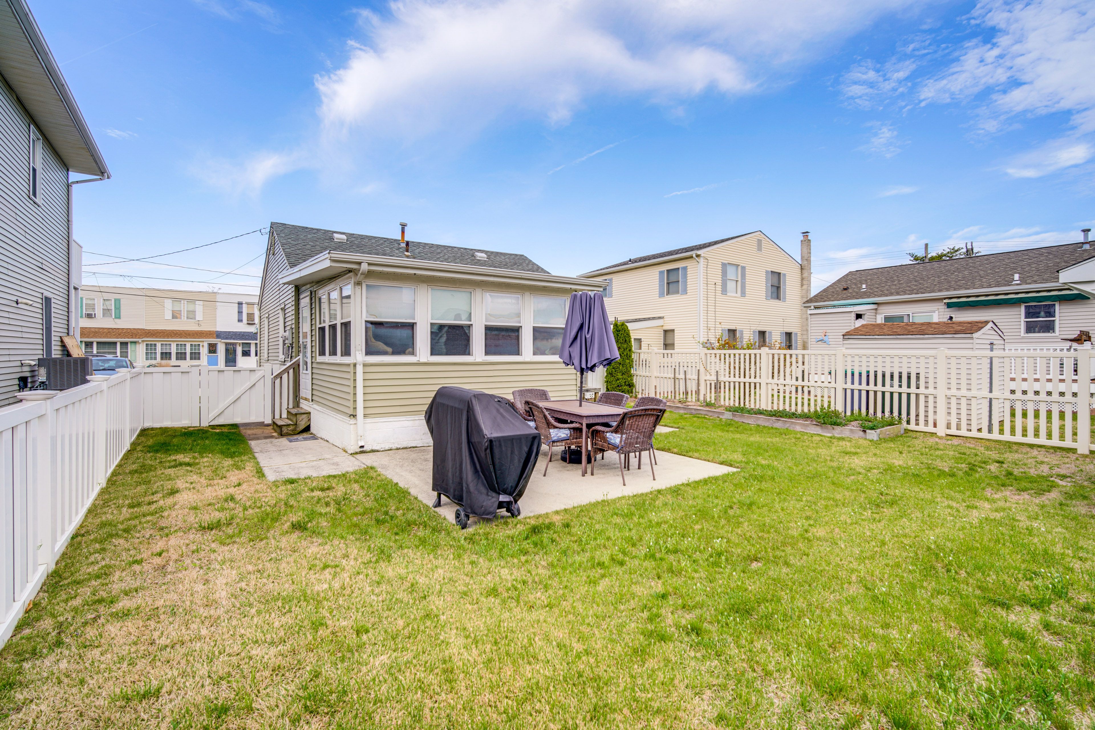 House Exterior | Patio | Dining Area w/ Umbrella | Gas Grill | Fenced Backyard