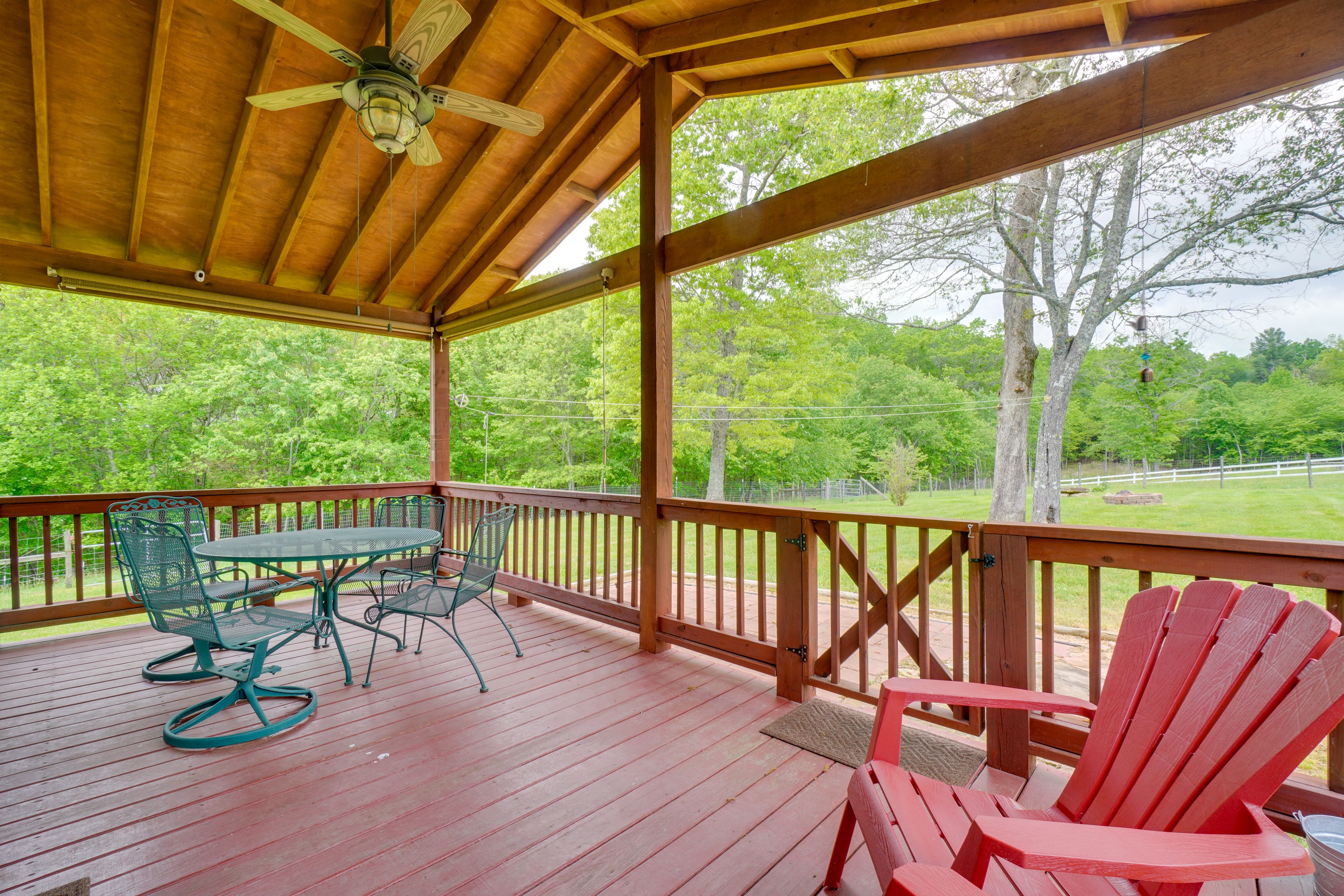 House Exterior | Covered Deck w/ Seating | Dining Area