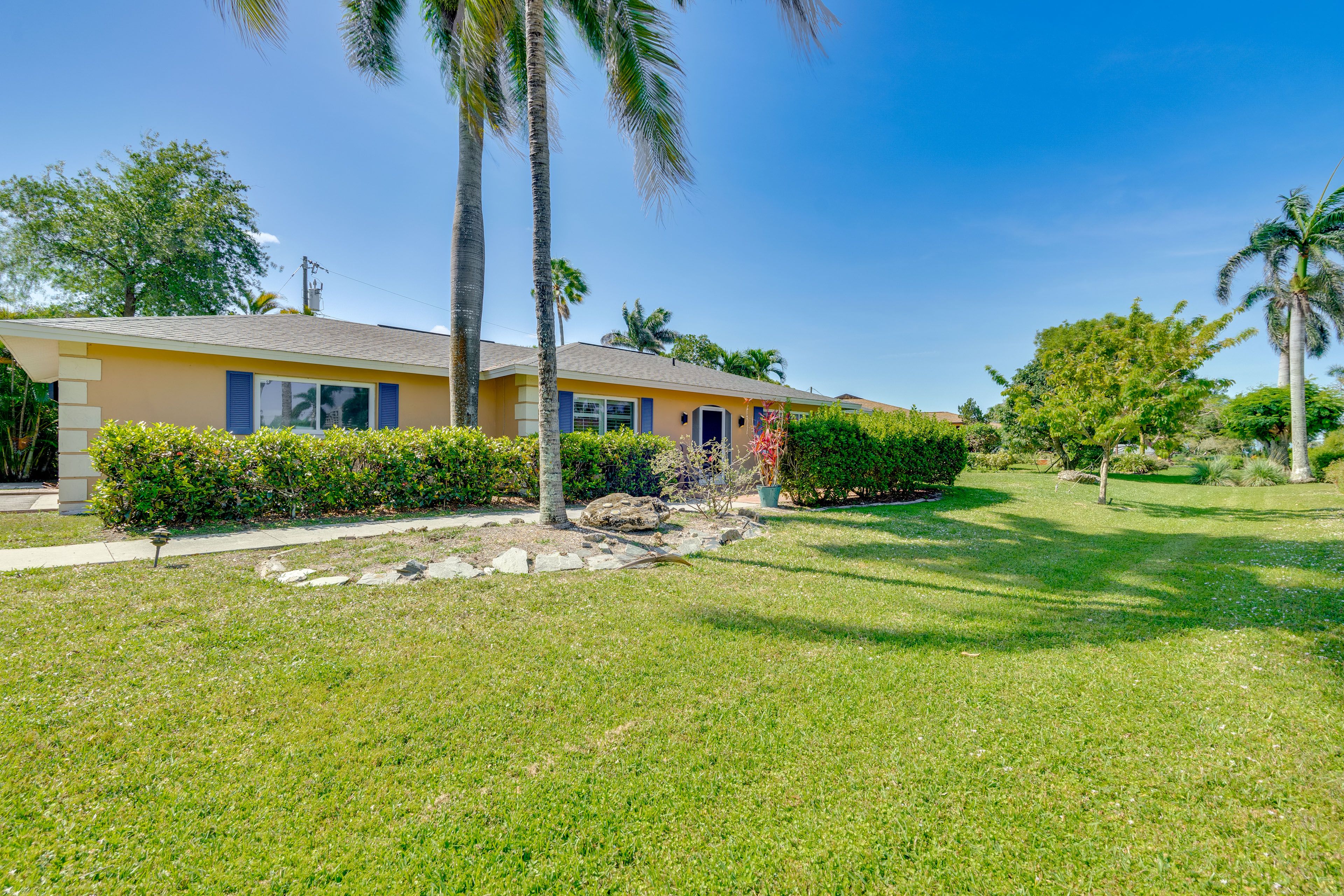 Property Exterior | Single-Story Home | Screened Lanai w/ Pool