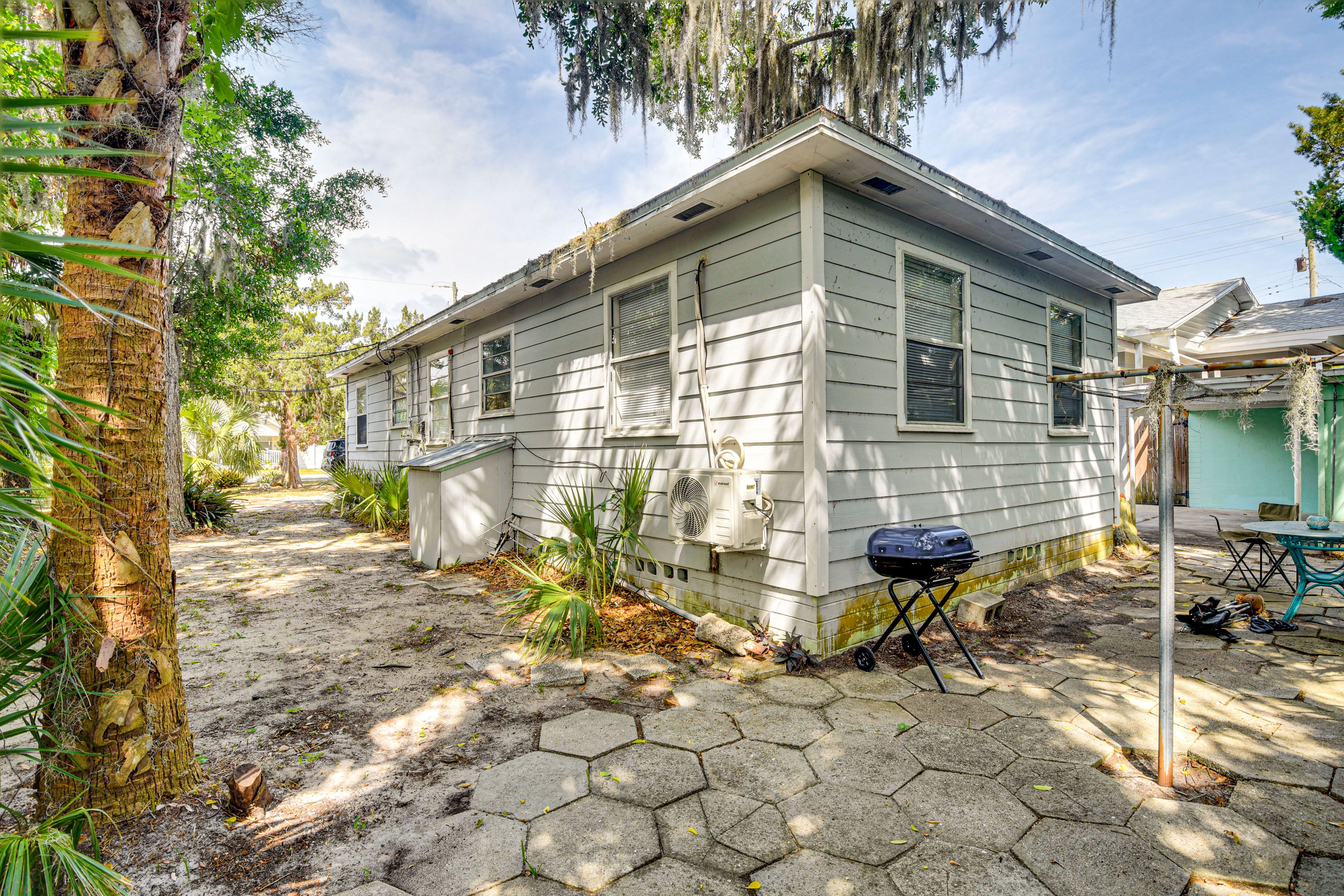 Partially Fenced Backyard | Charcoal Grill | Table