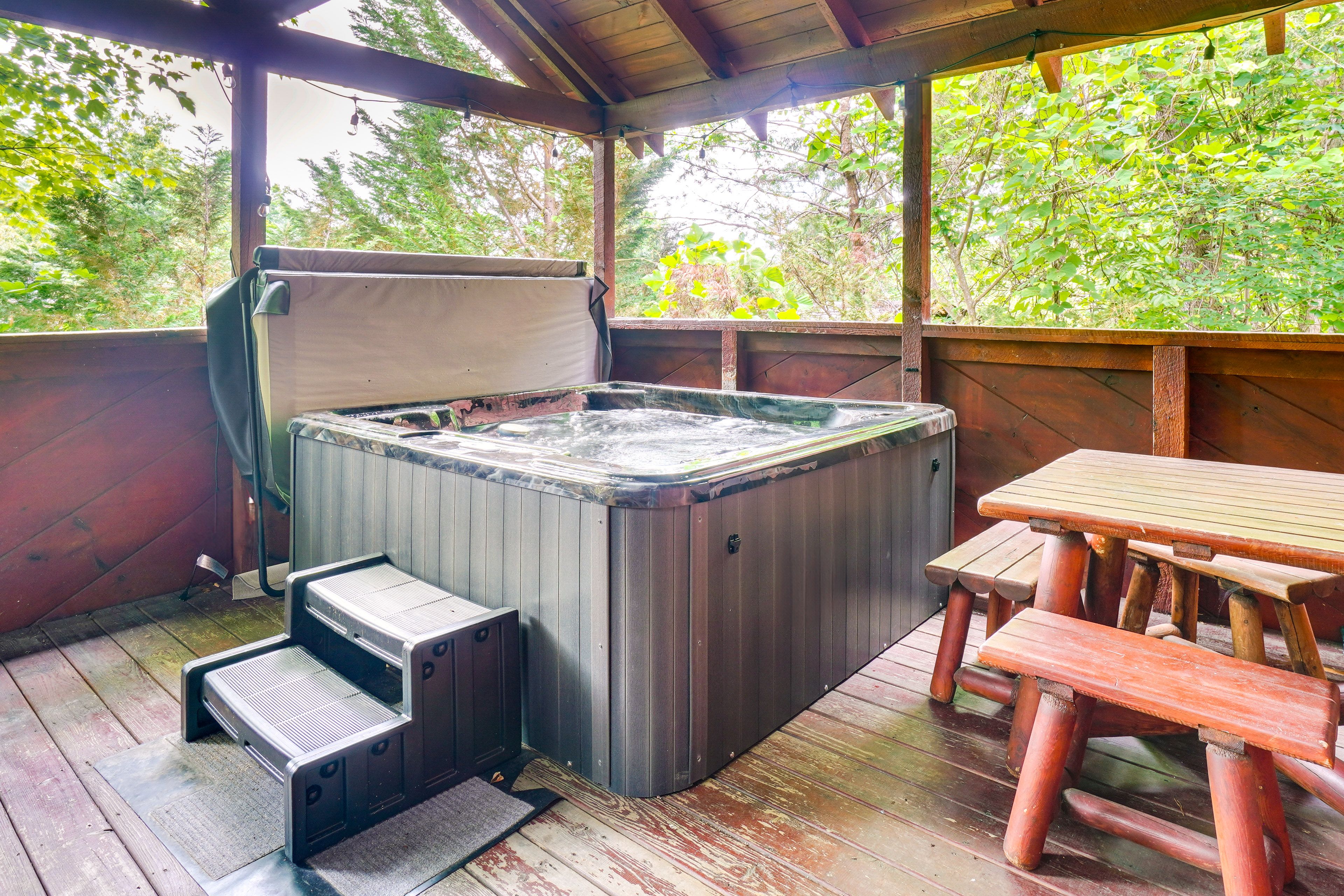 Covered Deck | Private Hot Tub | Charcoal Grill | Outdoor Dining Area
