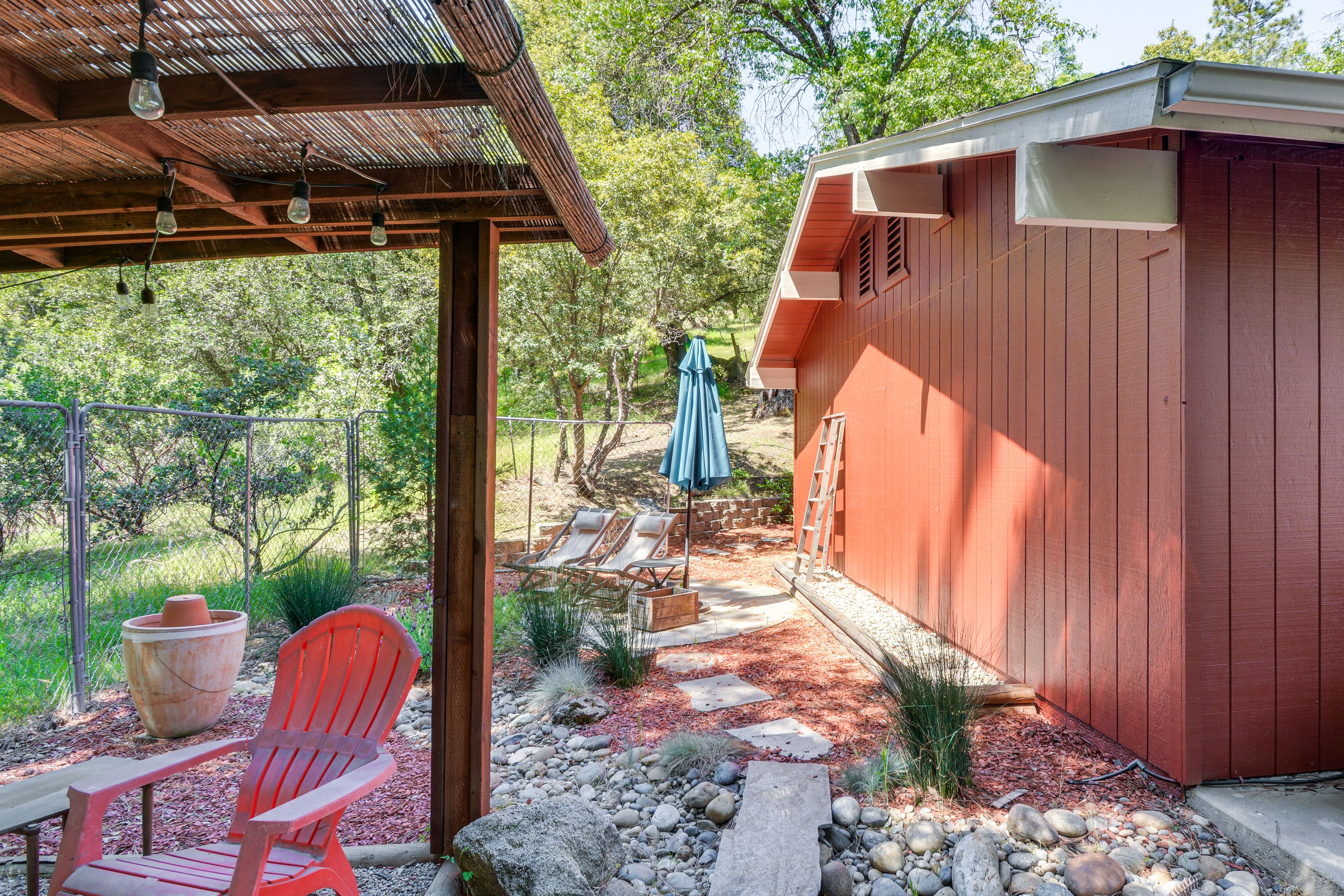 Cabin Exterior | Patio w/ Seating & Umbrella