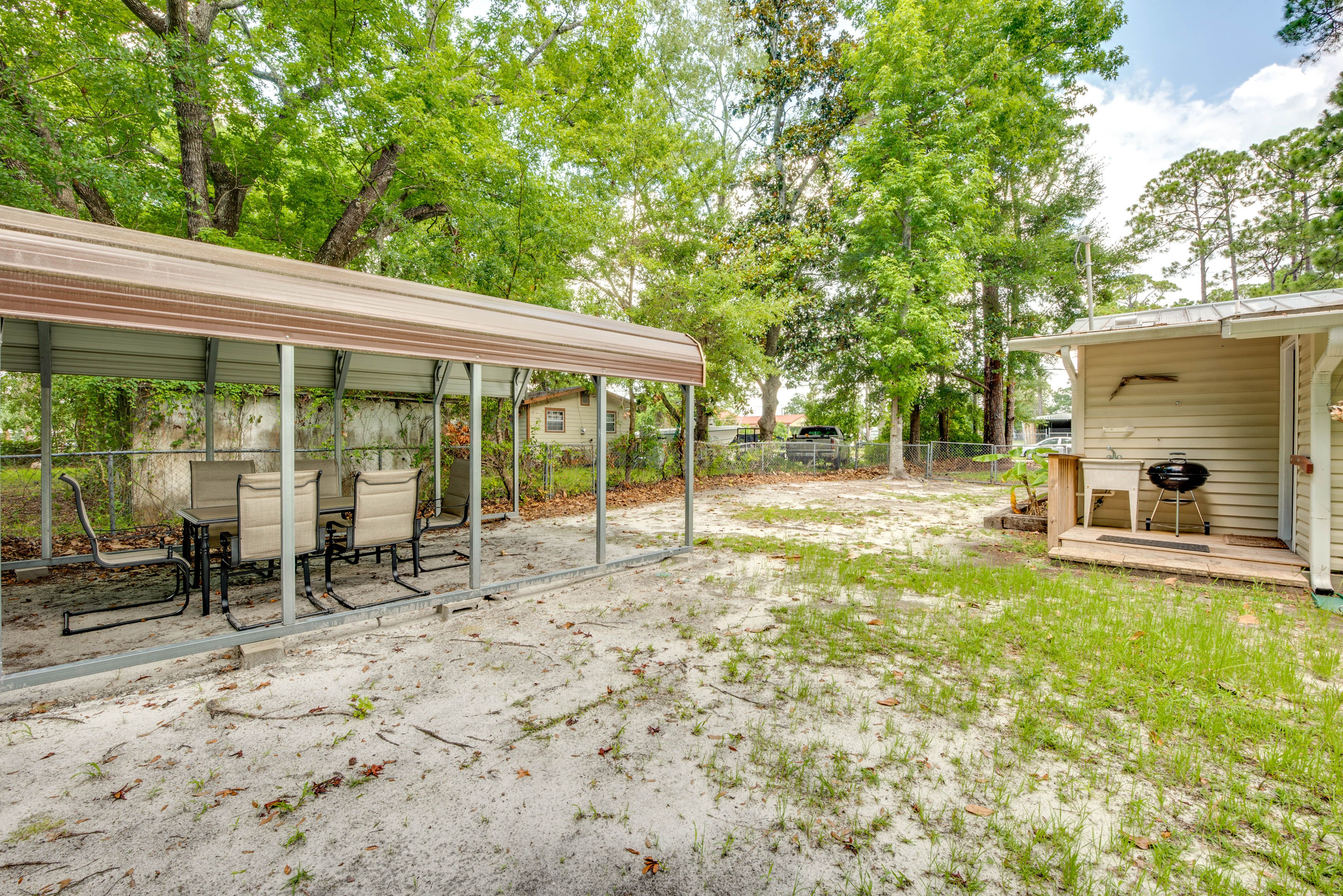 House Exterior | Covered Dining Area | Charcoal Grill | Fenced Backyard