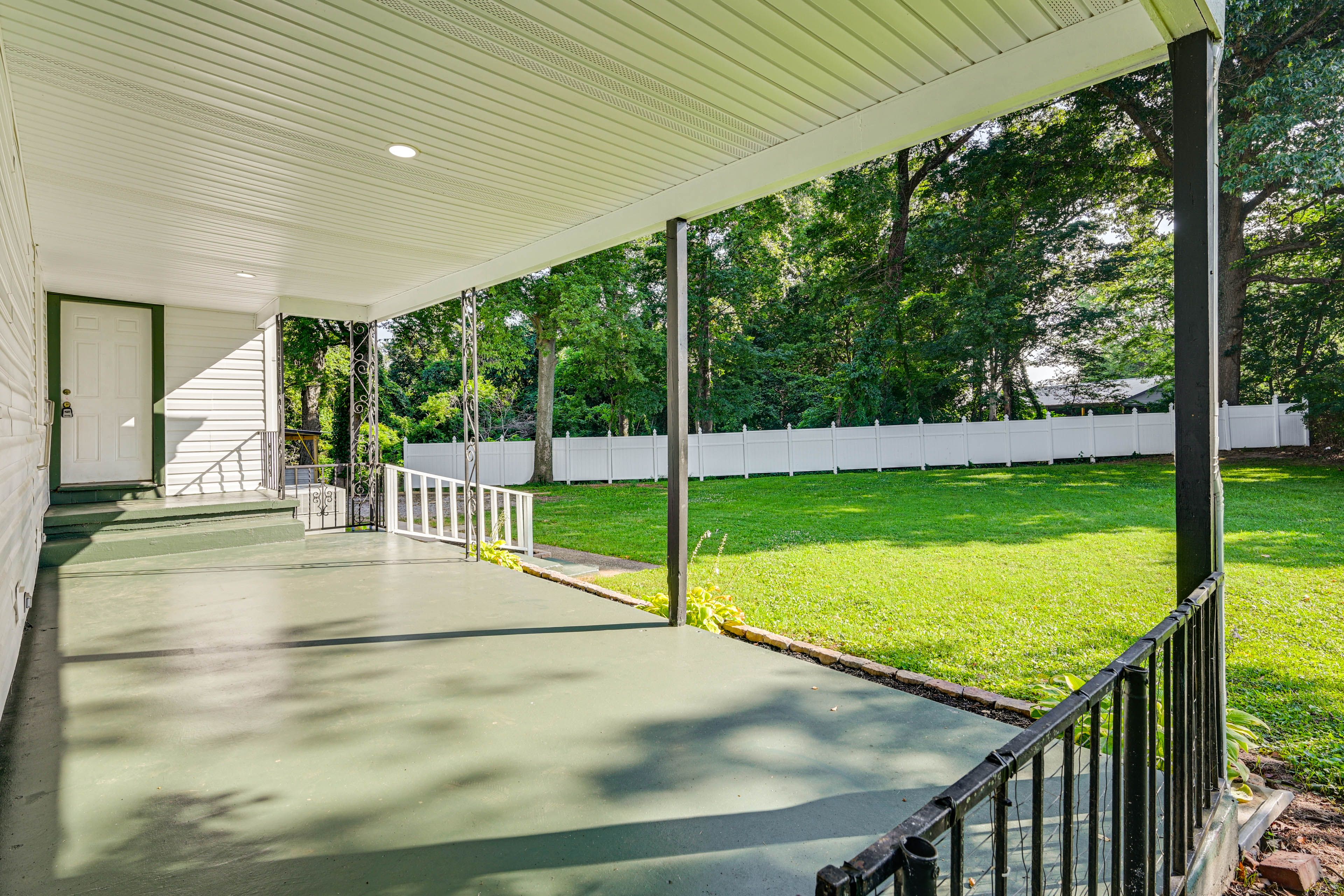 Property Exterior | Covered Porch | Spacious Yard