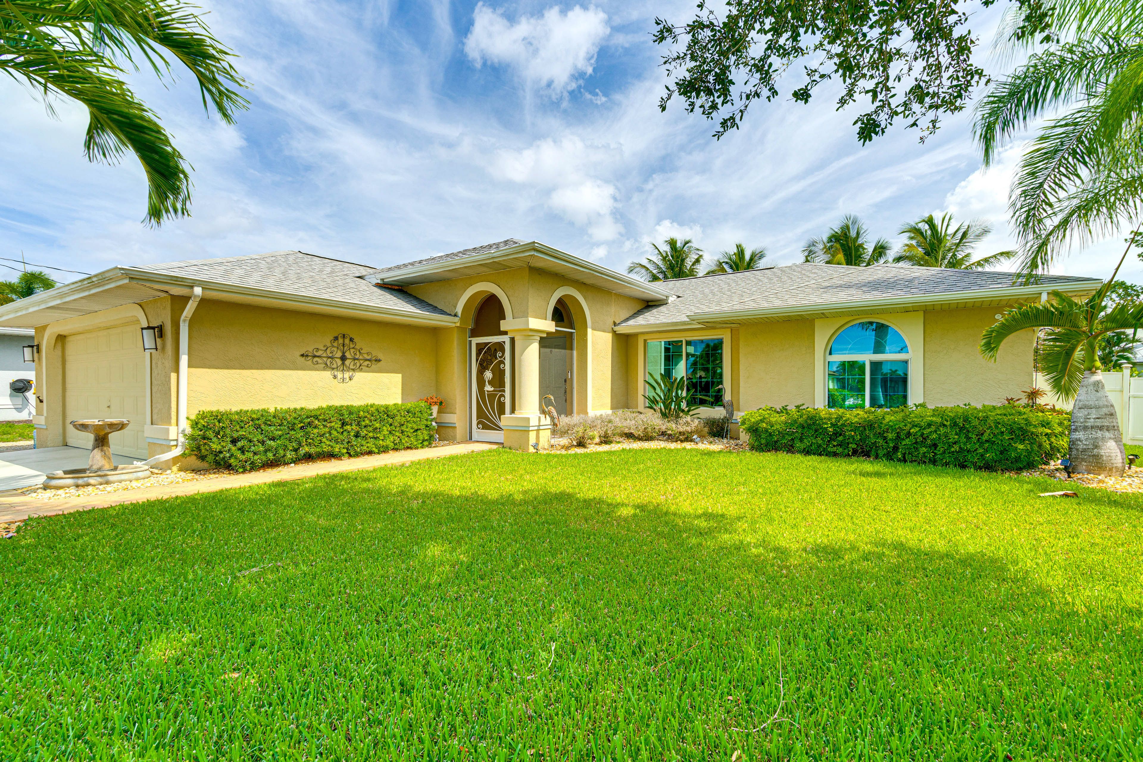 Property Exterior | Fenced-In Yard | Private Pool w/ Spa & Slide | Grill