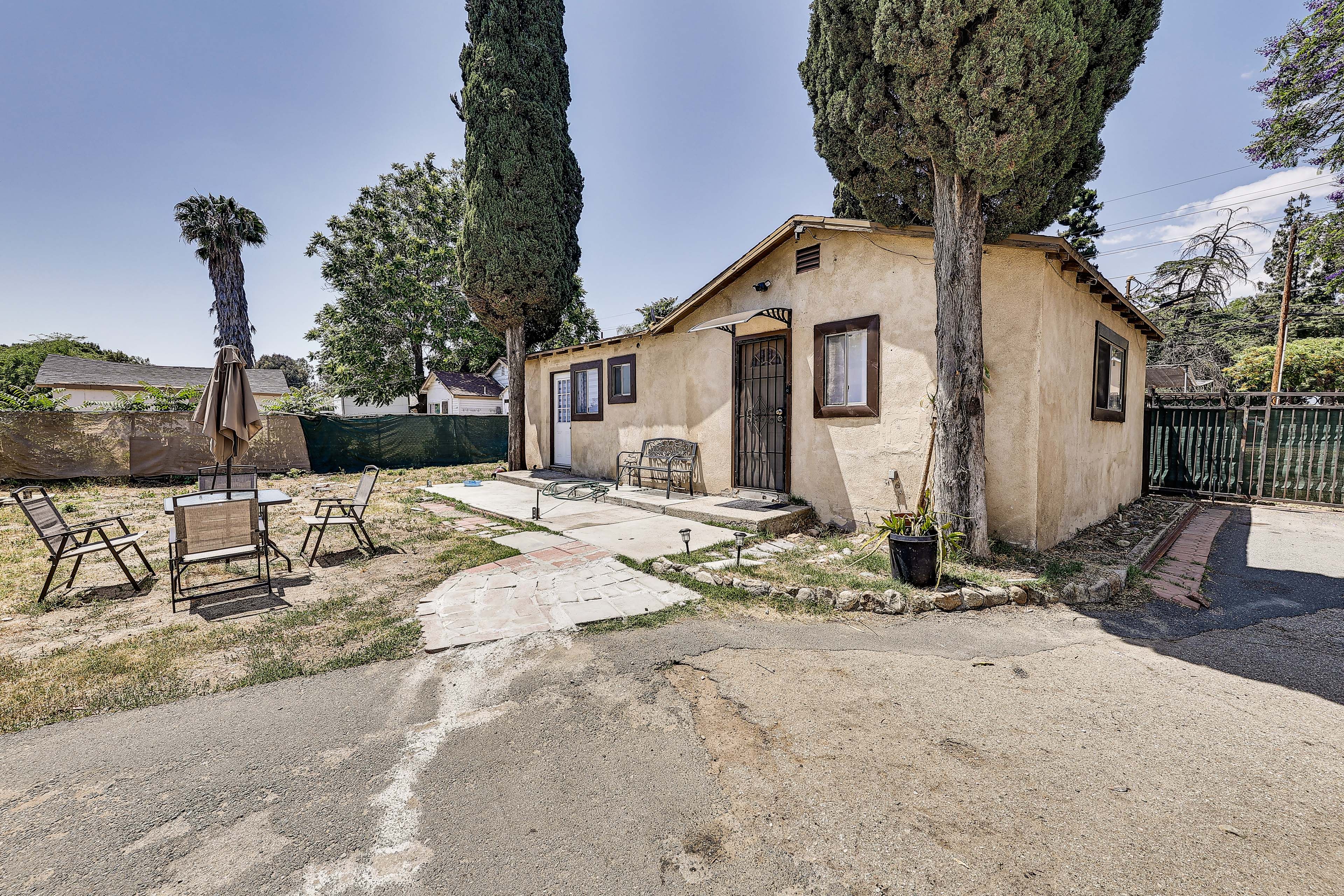 House Exterior | Dining Area w/ Umbrella | Fenced Yard