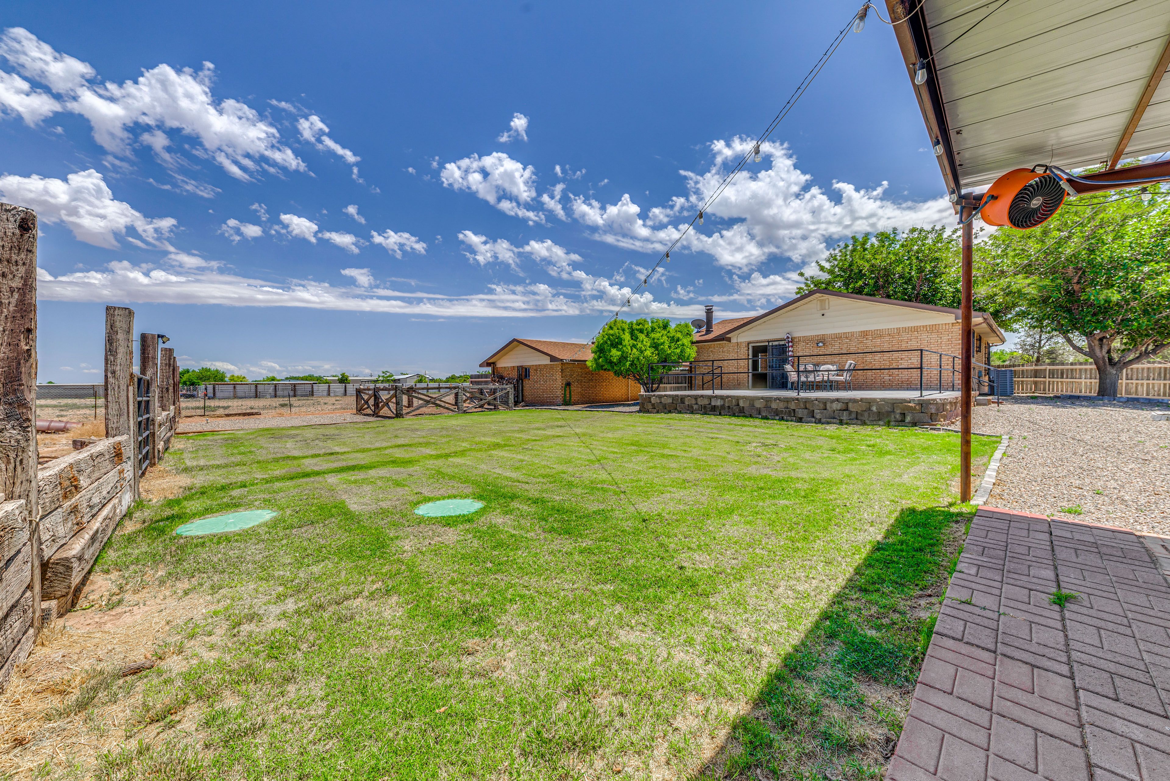 Property Exterior | Spacious Yard | Covered Patio w/ BBQ Area