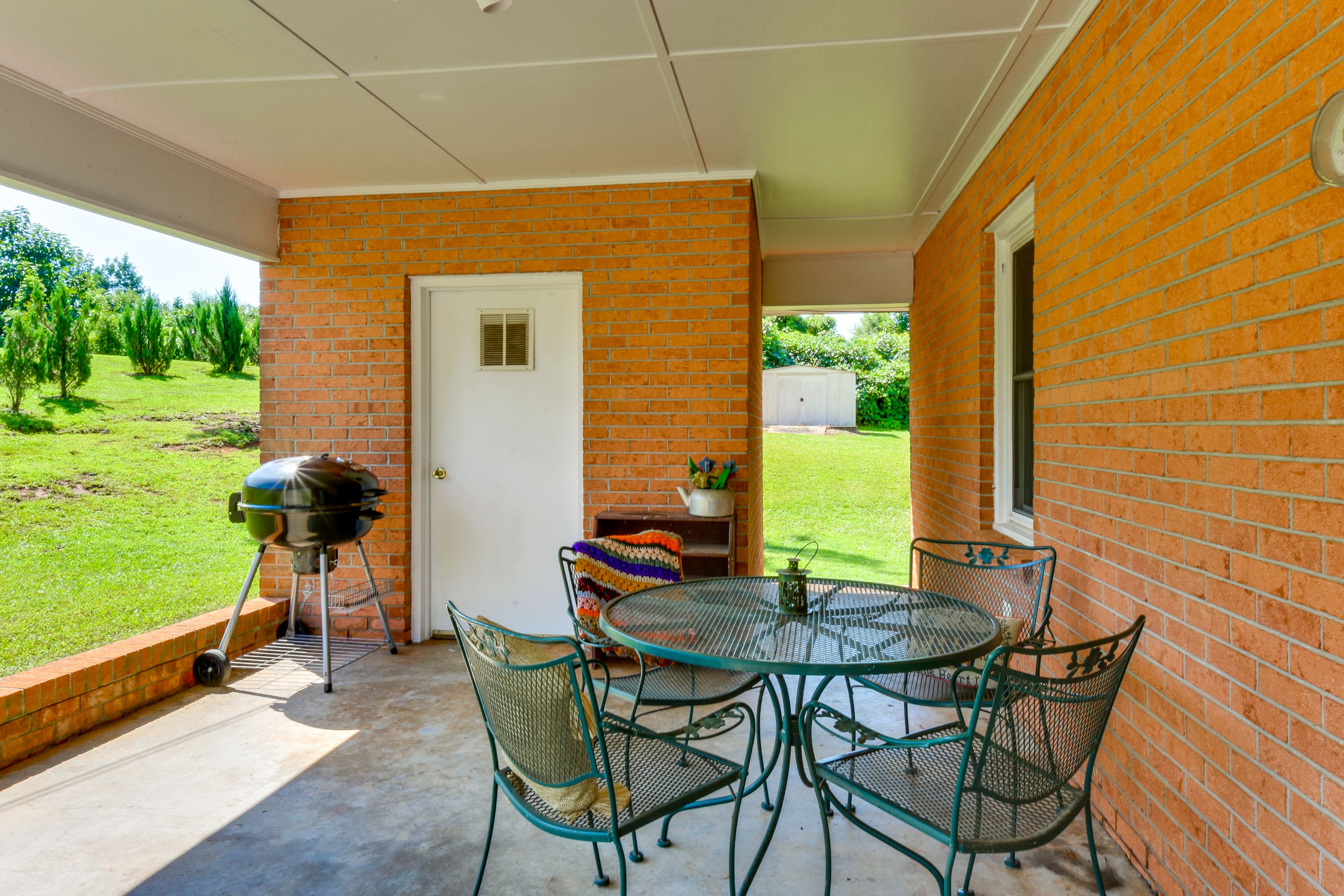 Property Exterior | Single-Story Home | Covered Patio w/ Dining Table
