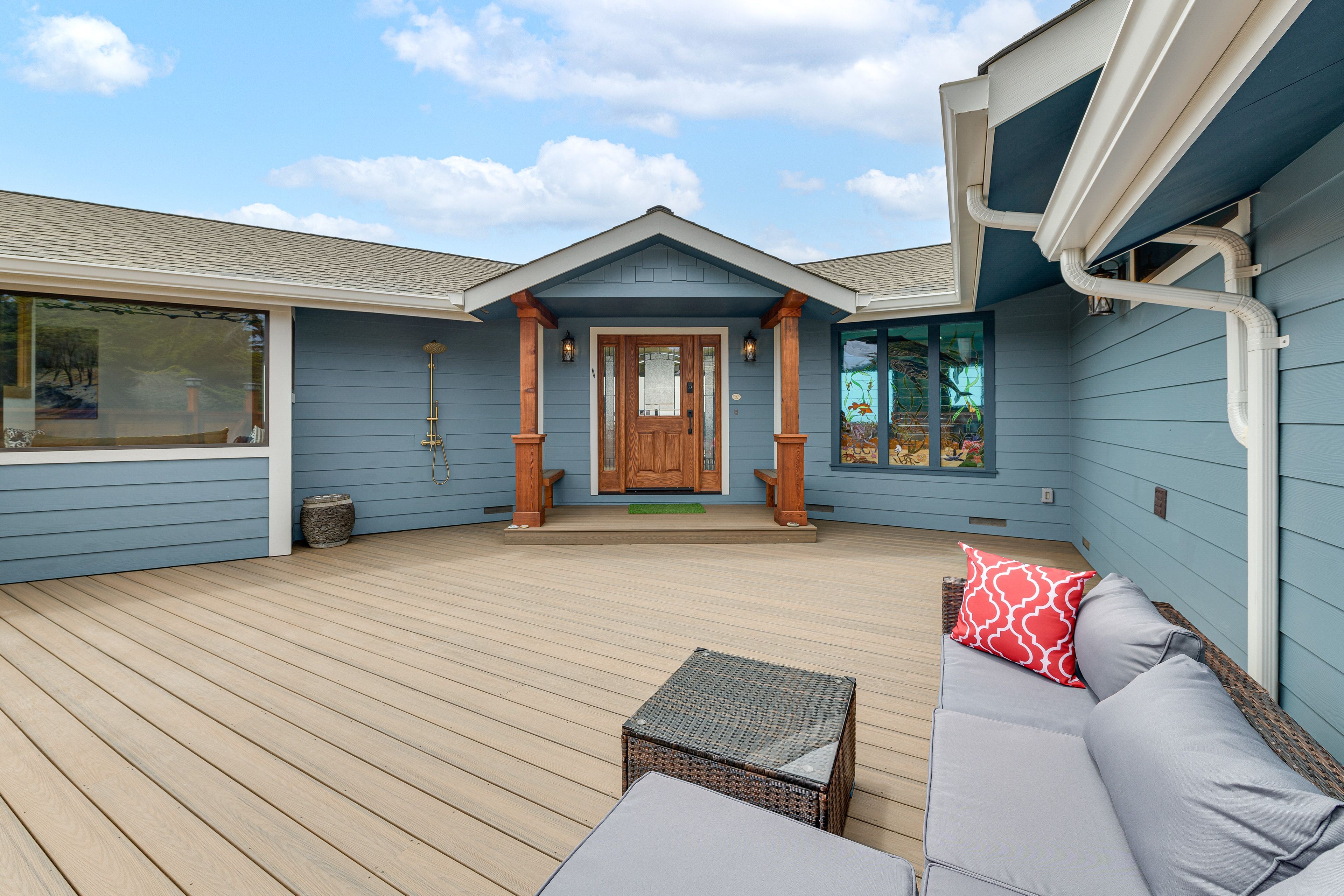 Property Exterior | Single-Story Home | Outdoor Shower | Porch w/ Seating
