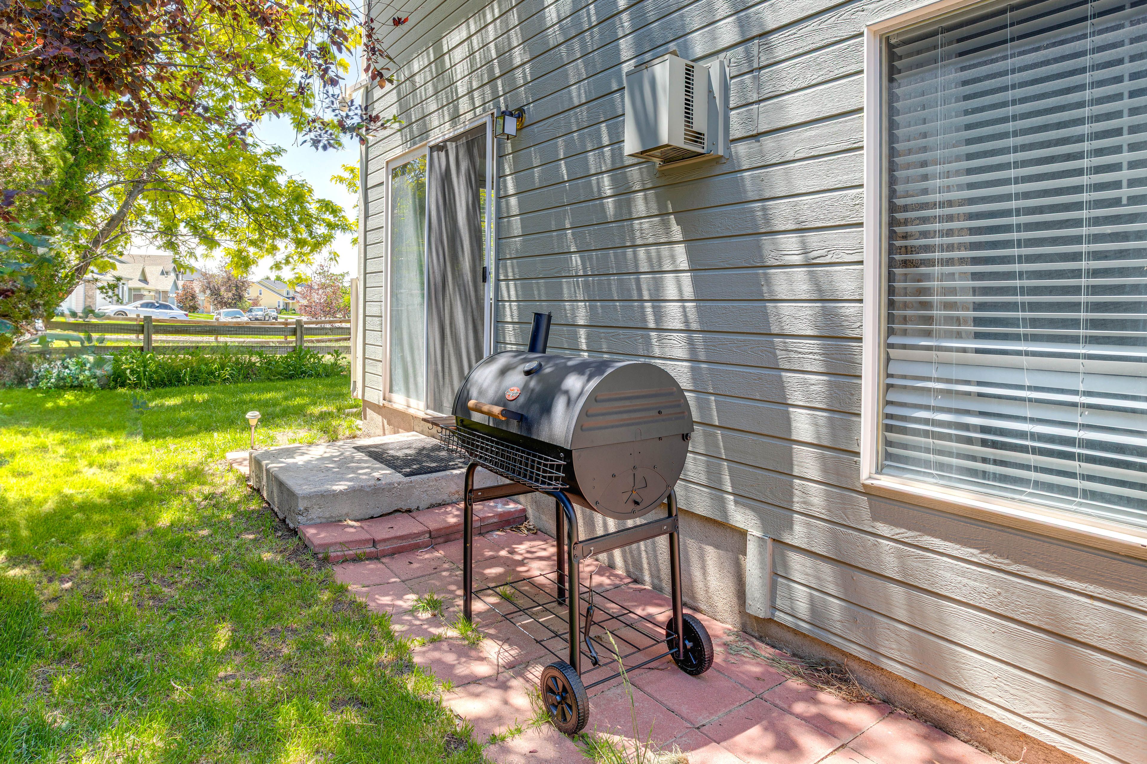 Fenced Backyard | Charcoal Grill | Outdoor Dining Area