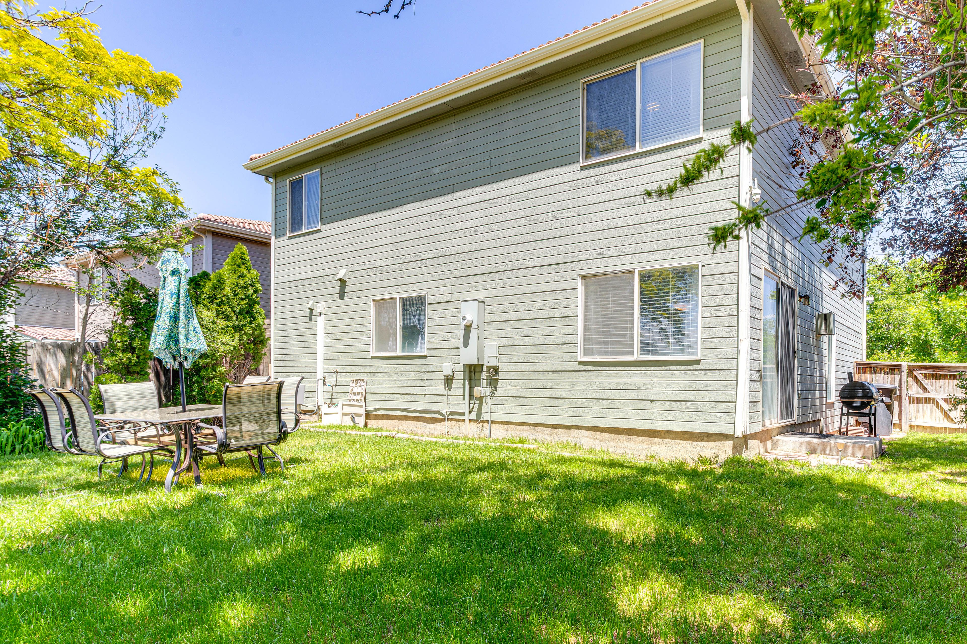 Fenced Backyard | Charcoal Grill | Outdoor Dining Area