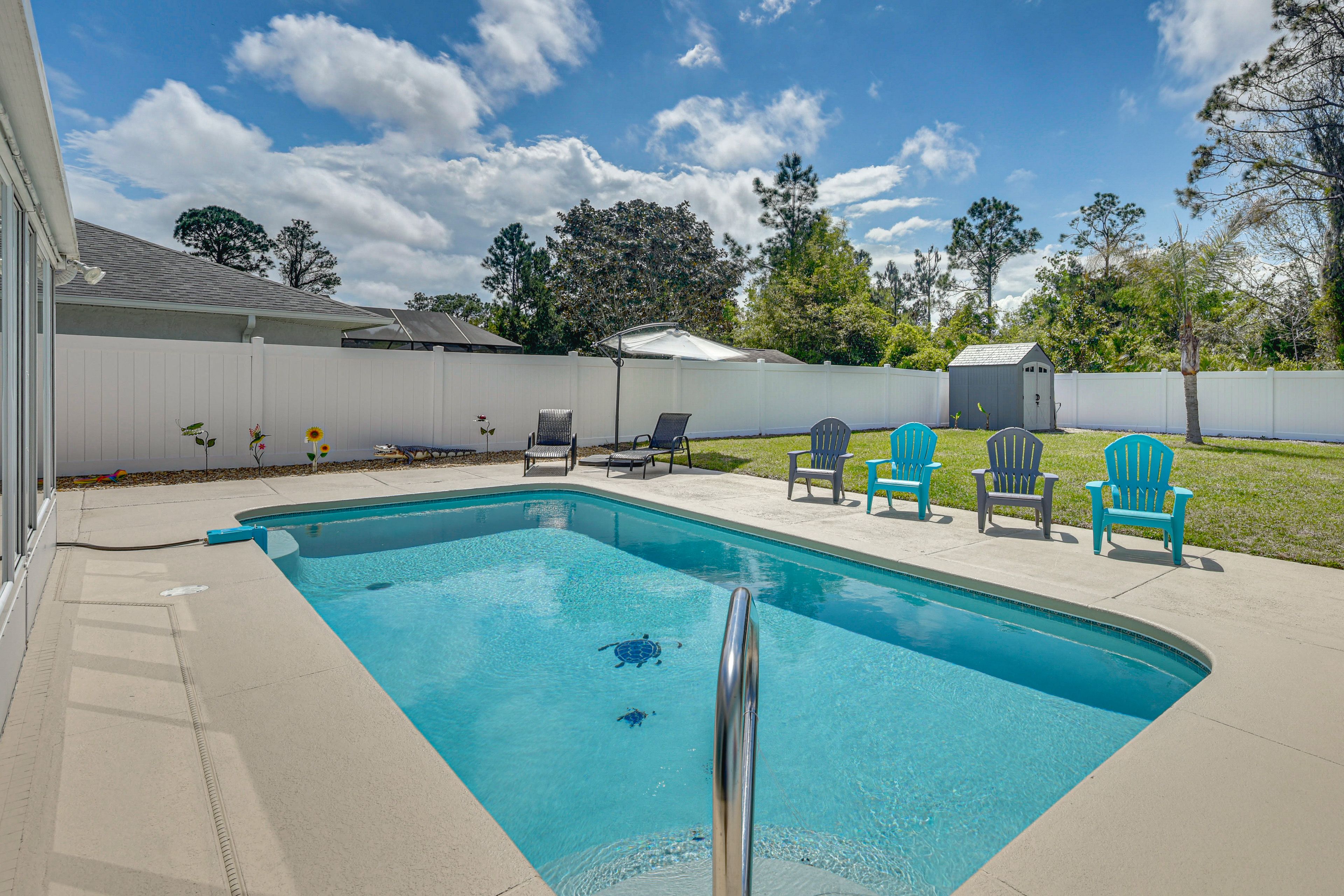 Pool AreaPalm Coast Vacation Rental | 3BR | 2BA | 1,535 Sq Ft | 1 Step to Enter