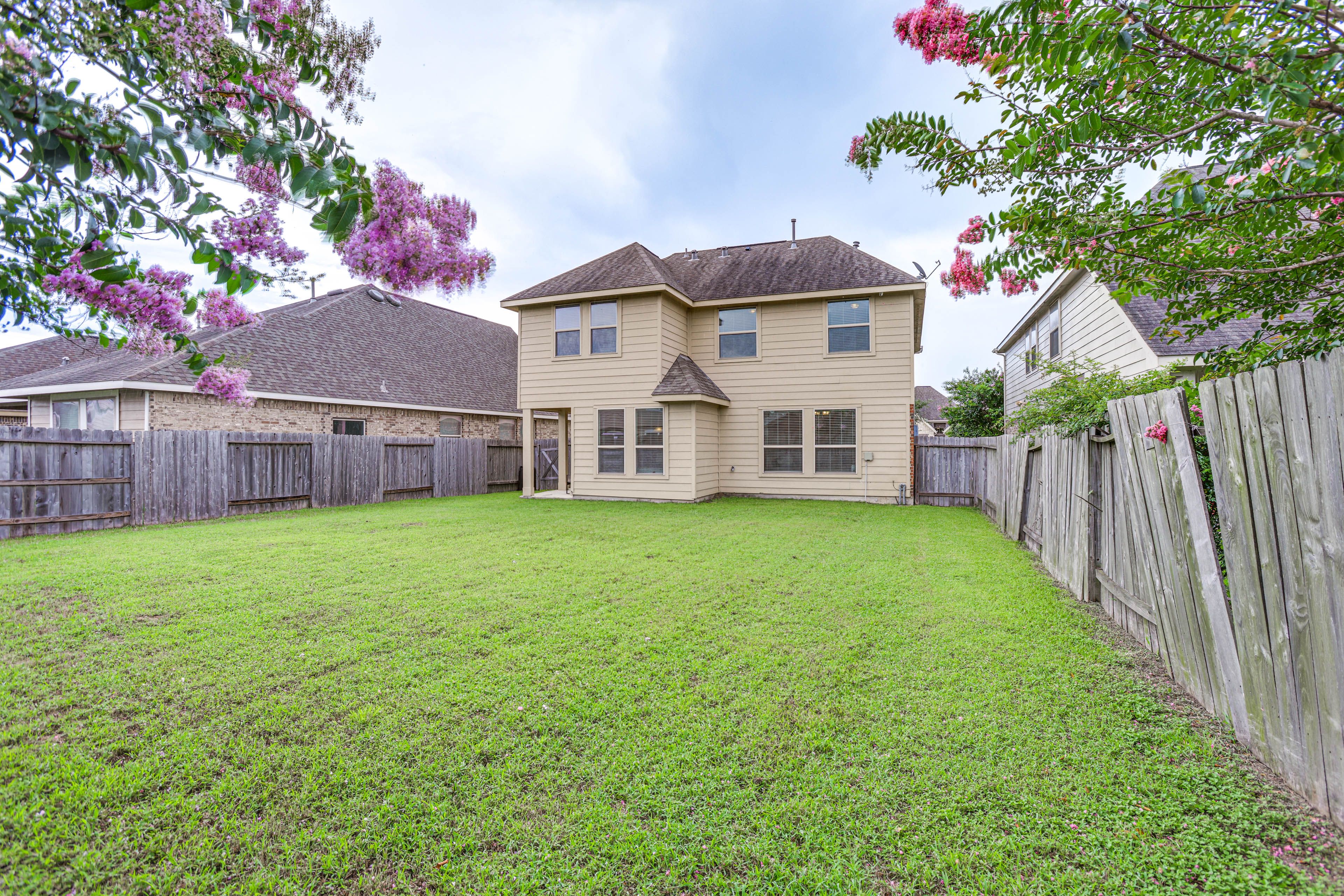 House Exterior | Covered Patio w/ Seating | Fenced Backyard