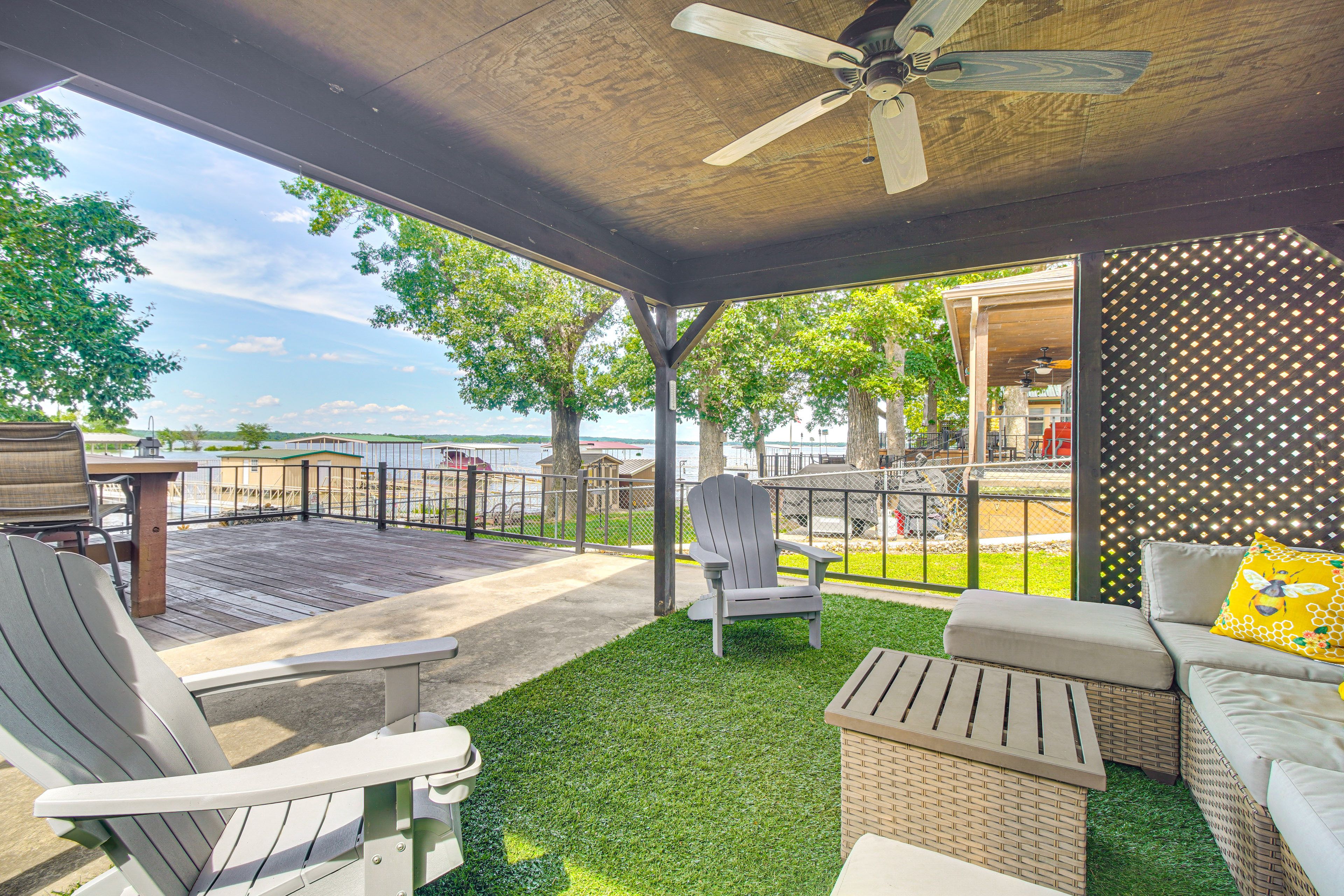 Cabin Exterior | Covered Deck w/ Seating | Lake Views & Access