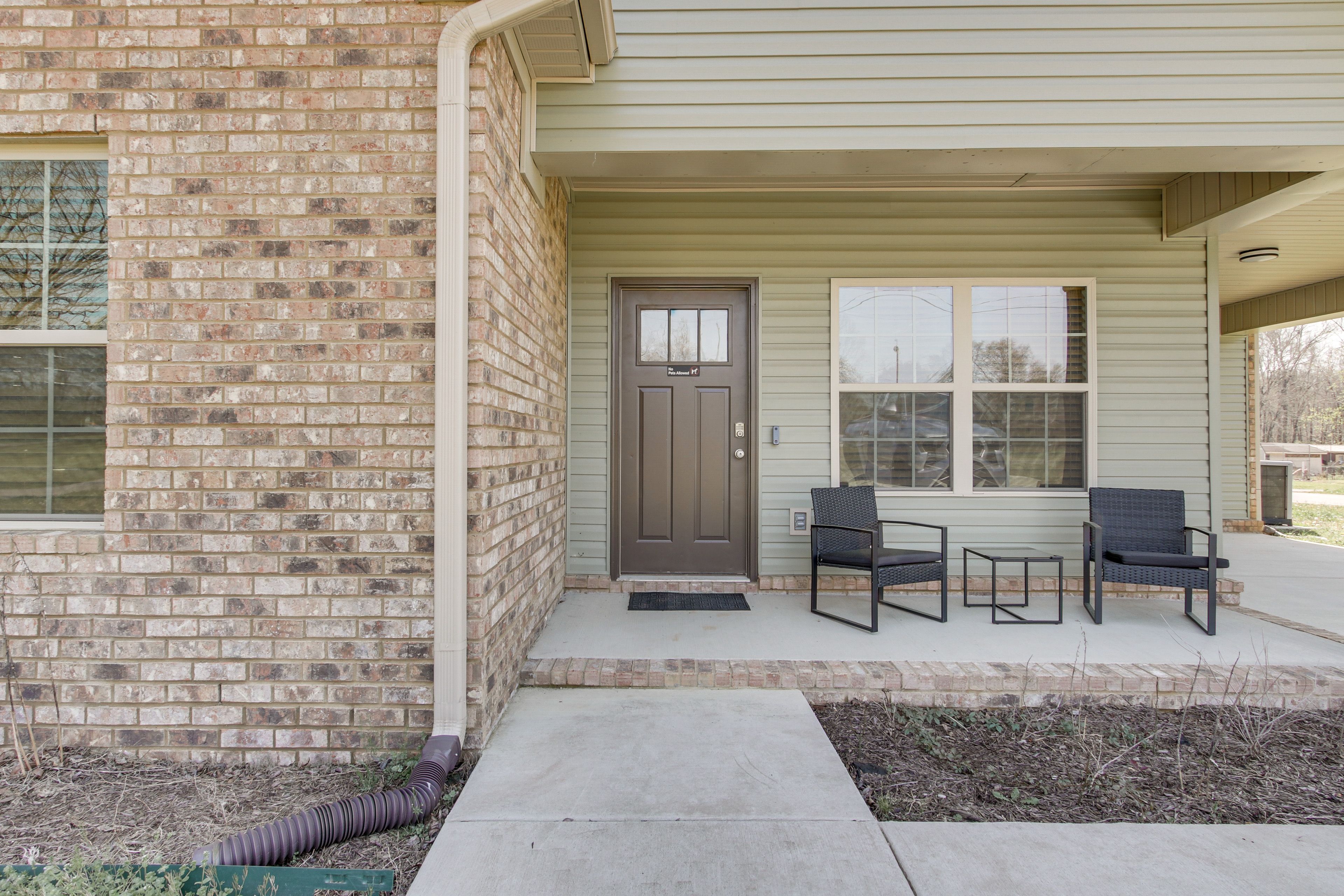 Property Exterior | Covered Porch w/ Seating | Spacious Yard