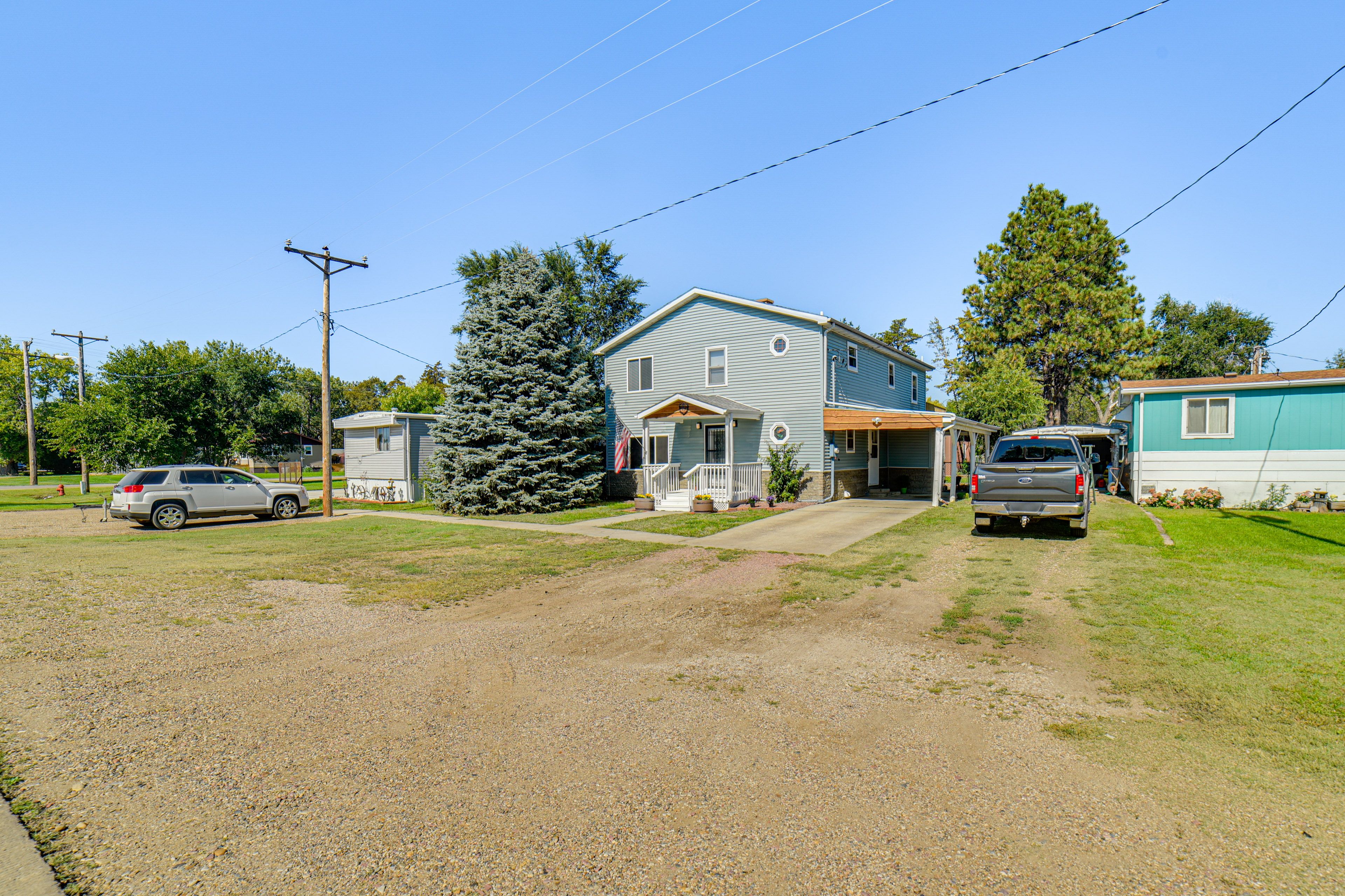House Exterior | Fenced Backyard | Screened-In Patio | Deck