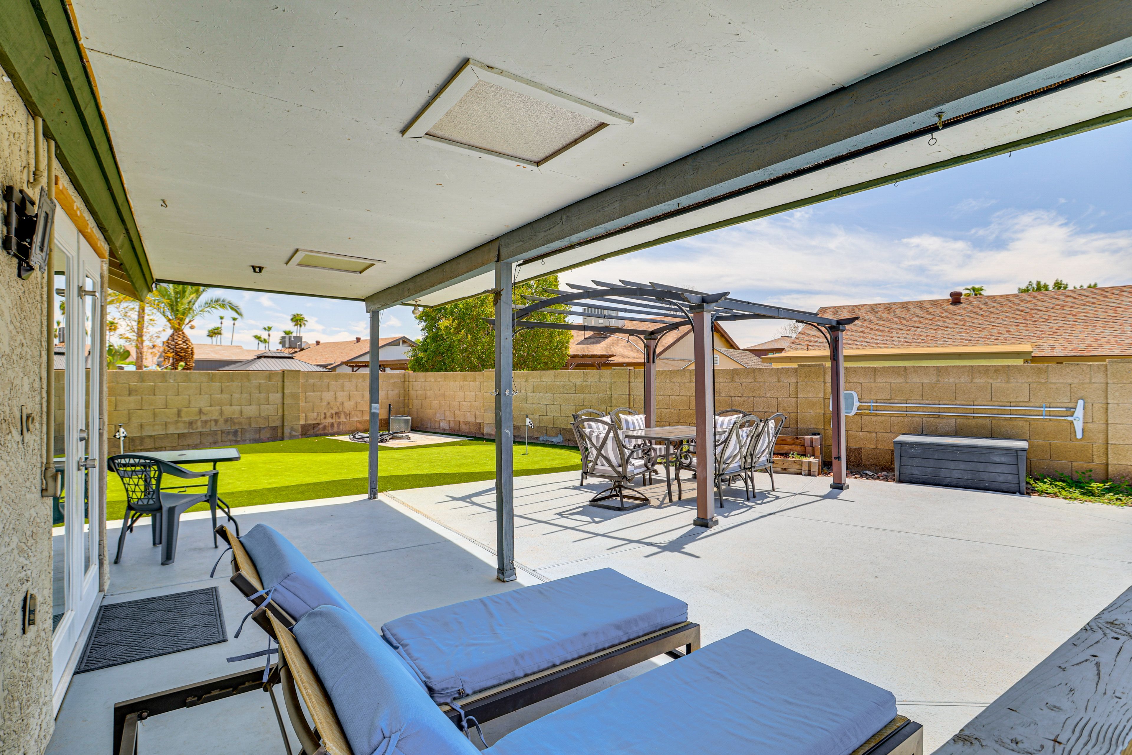 House Exterior | Covered Patio w/ Lounge Chairs | Pergola w/ Dining Area