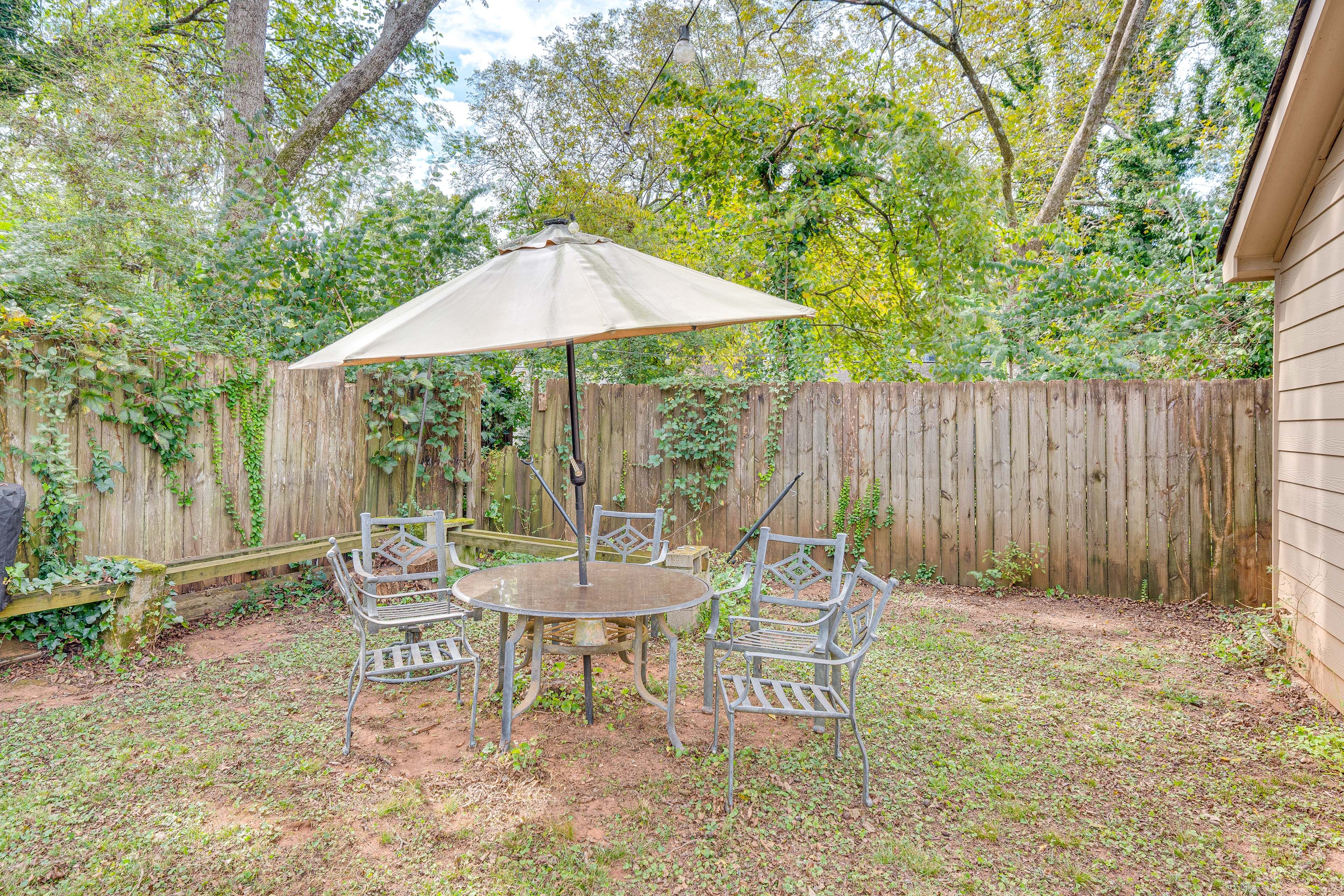 House Exterior | Dining Area w/ Umbrella | Gas & Charcoal Grill