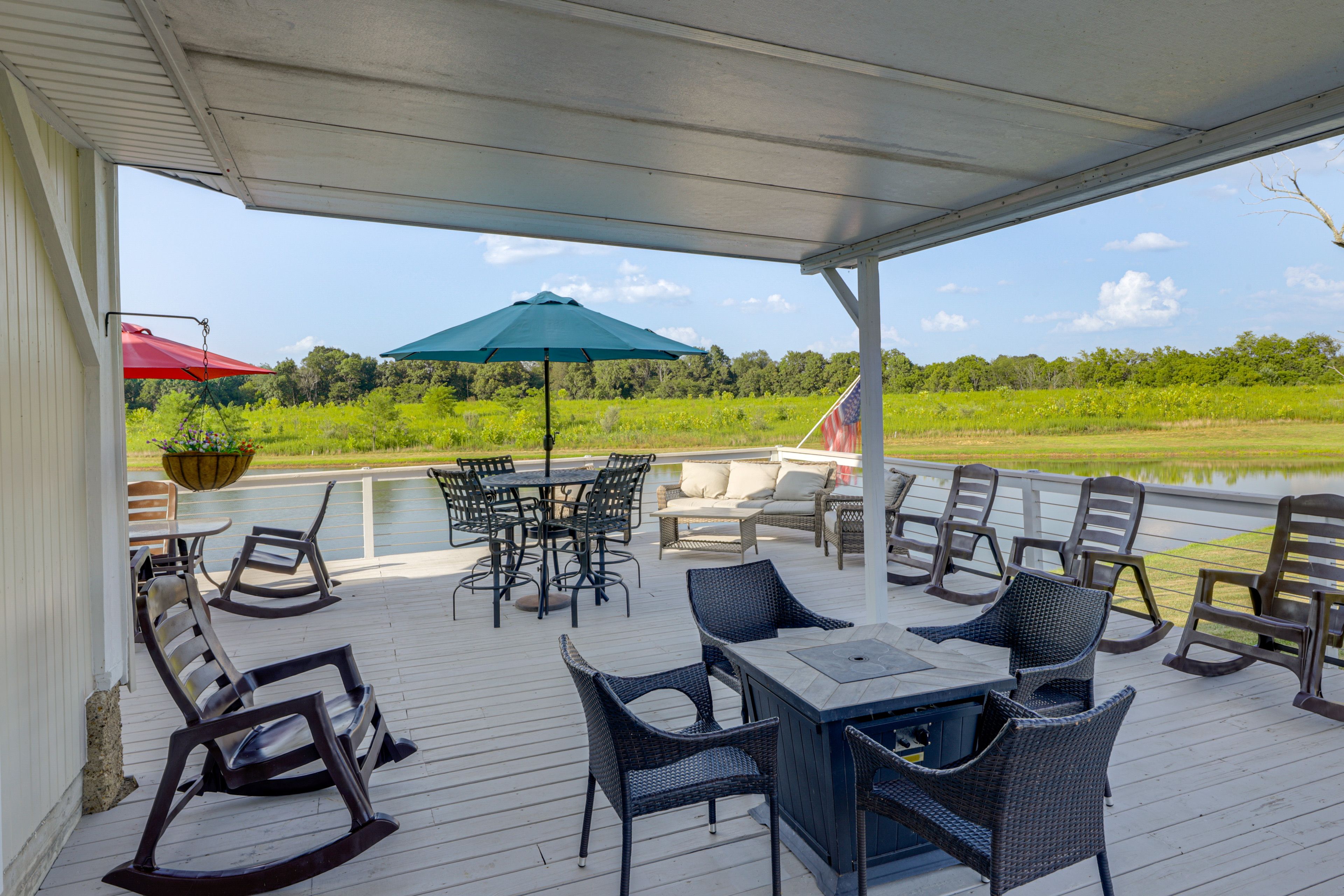 Property Exterior | Pond Access | Docks | Covered Porch w/ Seating