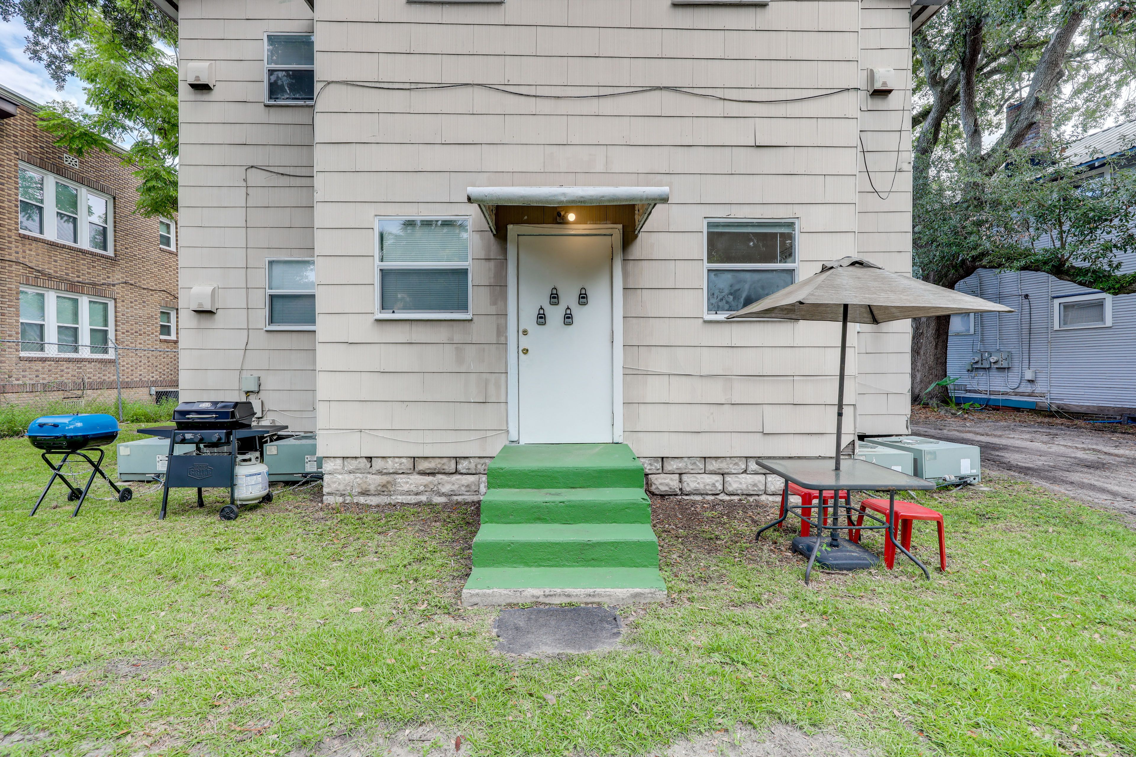 Condo Exterior | Gas & Charcoal Grills | Dining Area w/ Umbrella | Private Yard