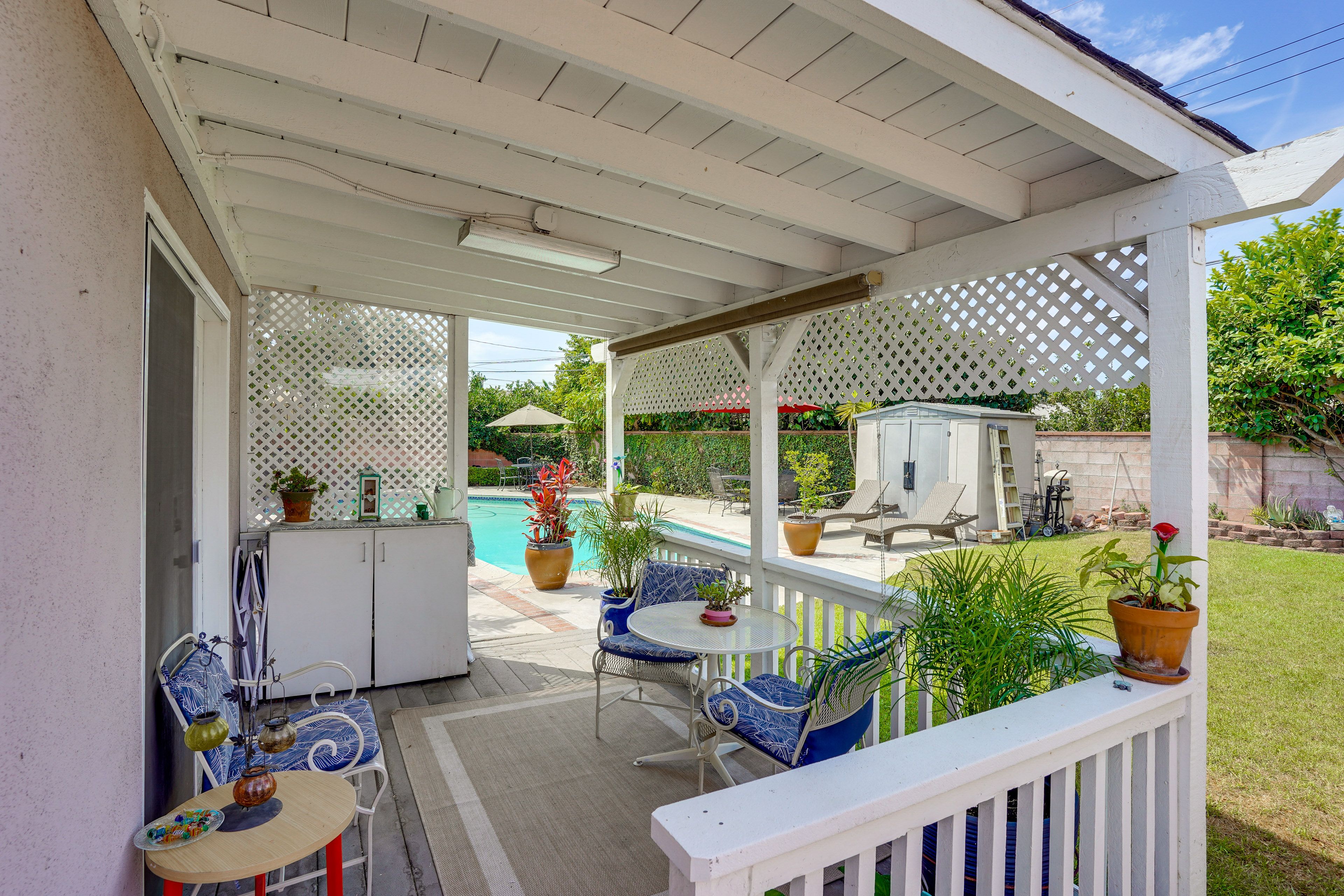 Property Exterior | Private Patio | Shared Backyard w/ Pool & Gas Grill