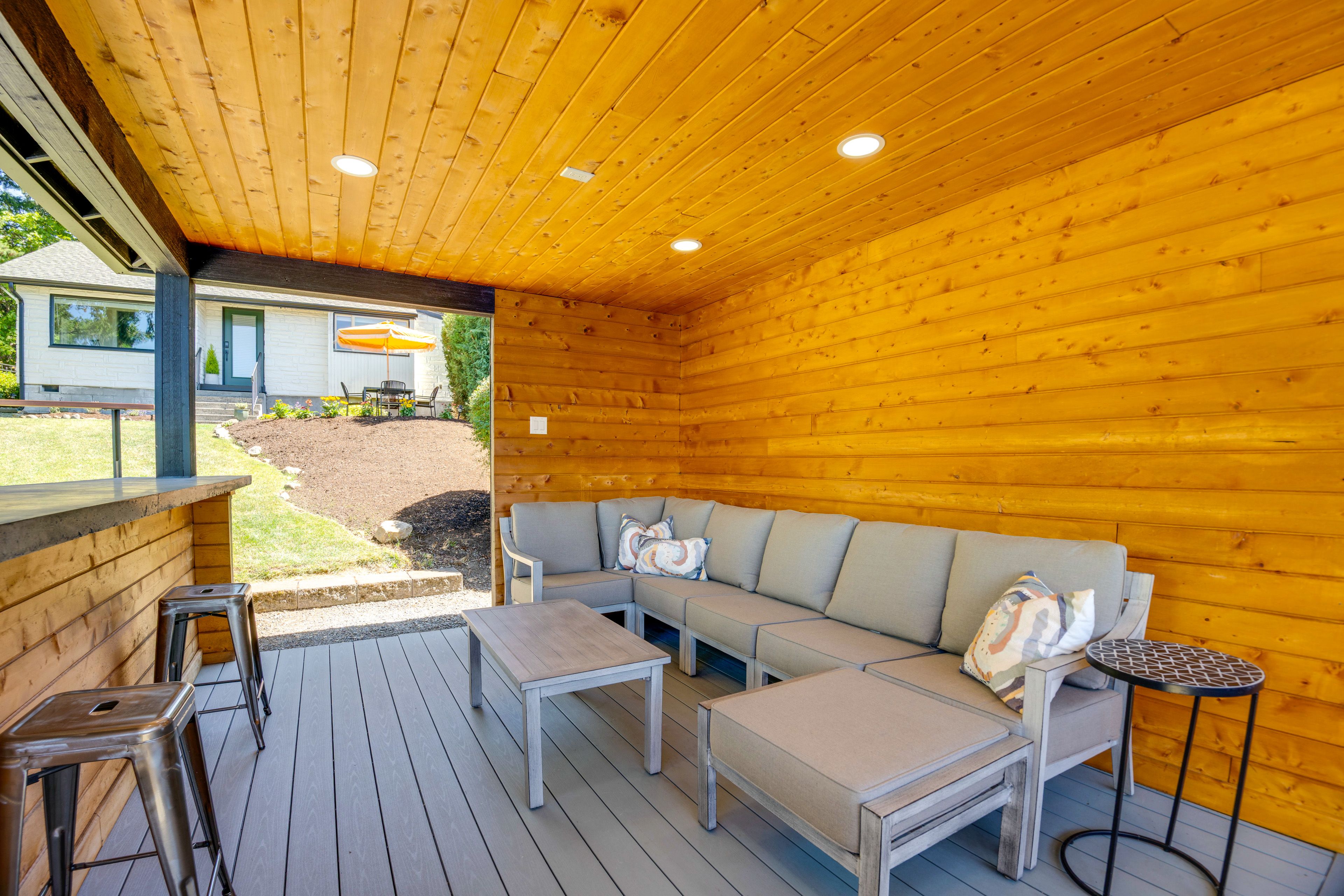 House Exterior | Covered Deck w/ Seating | Lake Views