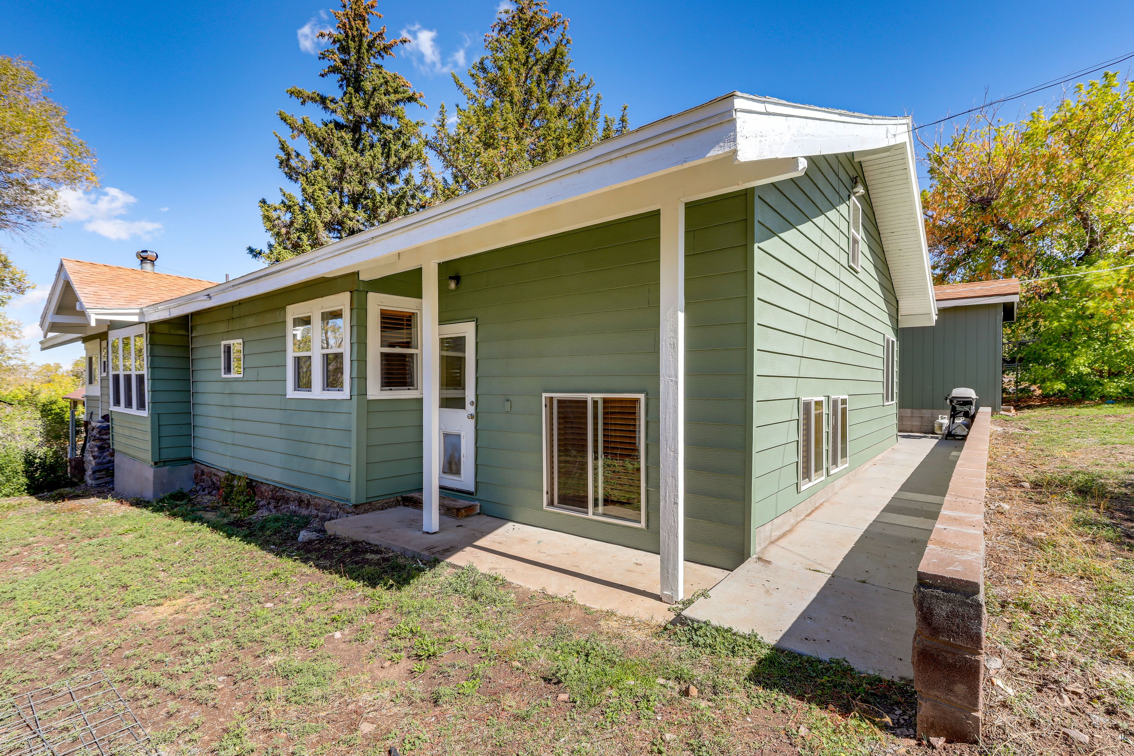 Property Exterior | Oversized Doggy Door | Fenced-In Yard | Gas Grill