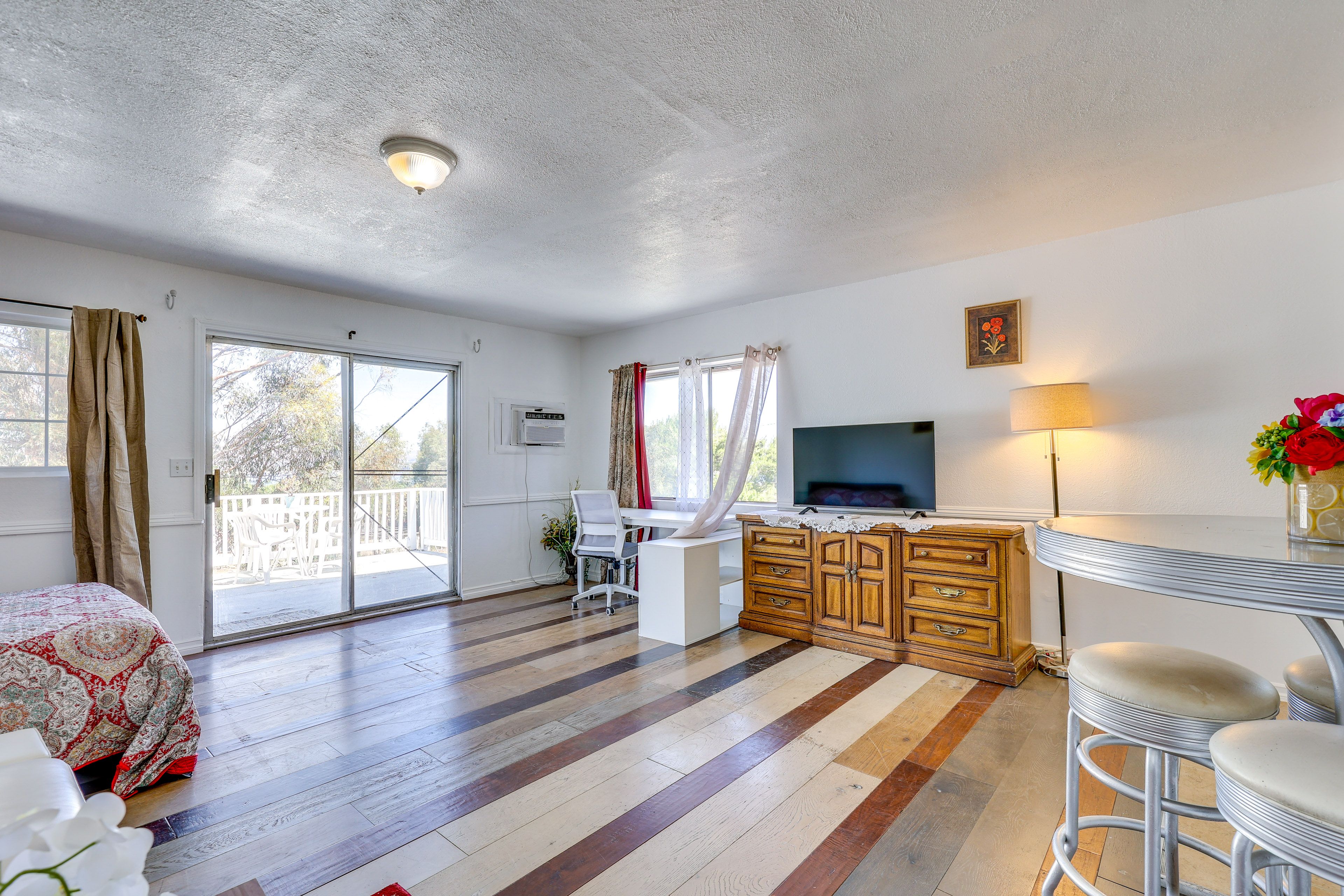 Studio | Queen Bed | Window A/C Unit | Central Heat | High-Top Dining Table