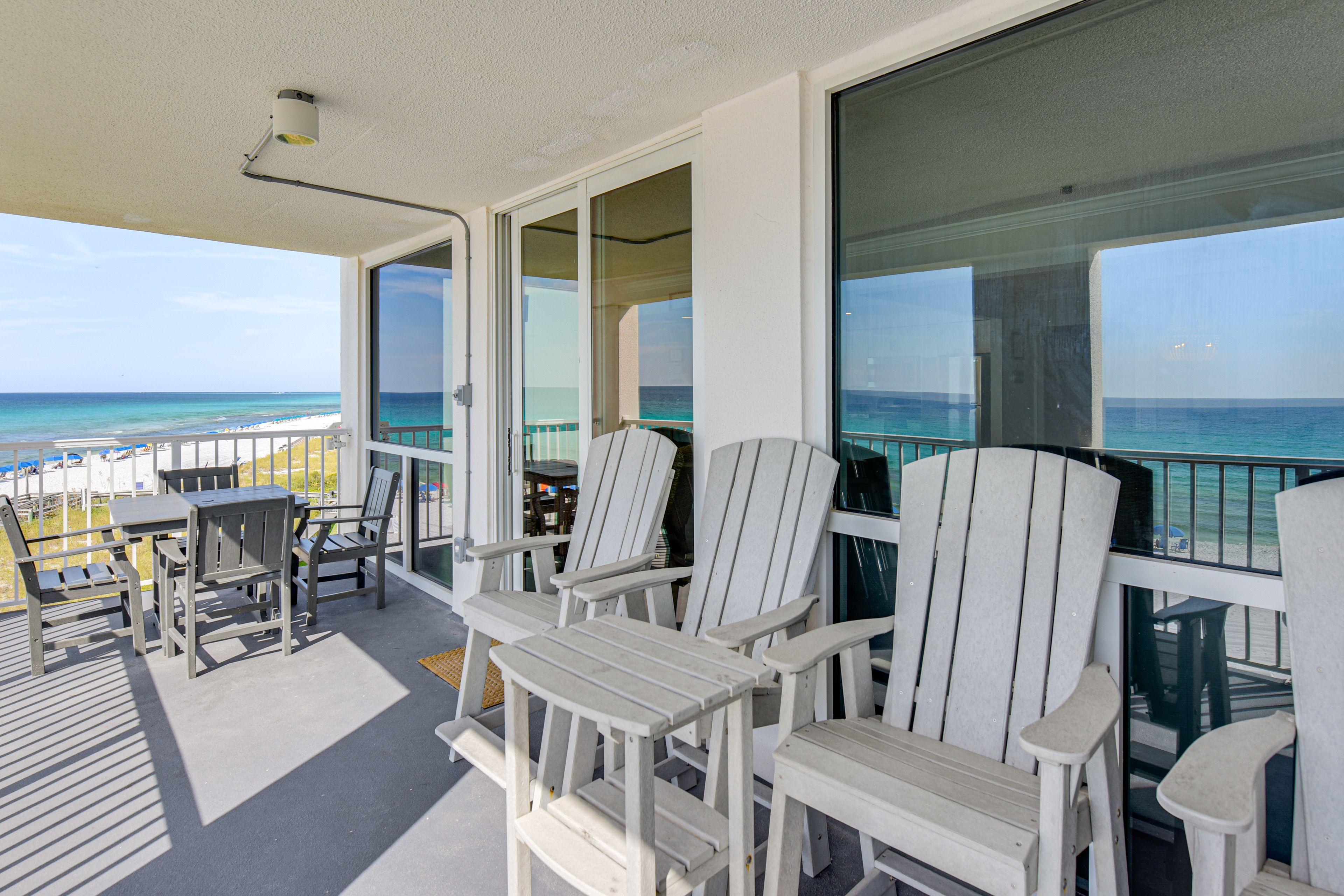 Condo Exterior | Covered Balcony w/ Seating | Dining Area