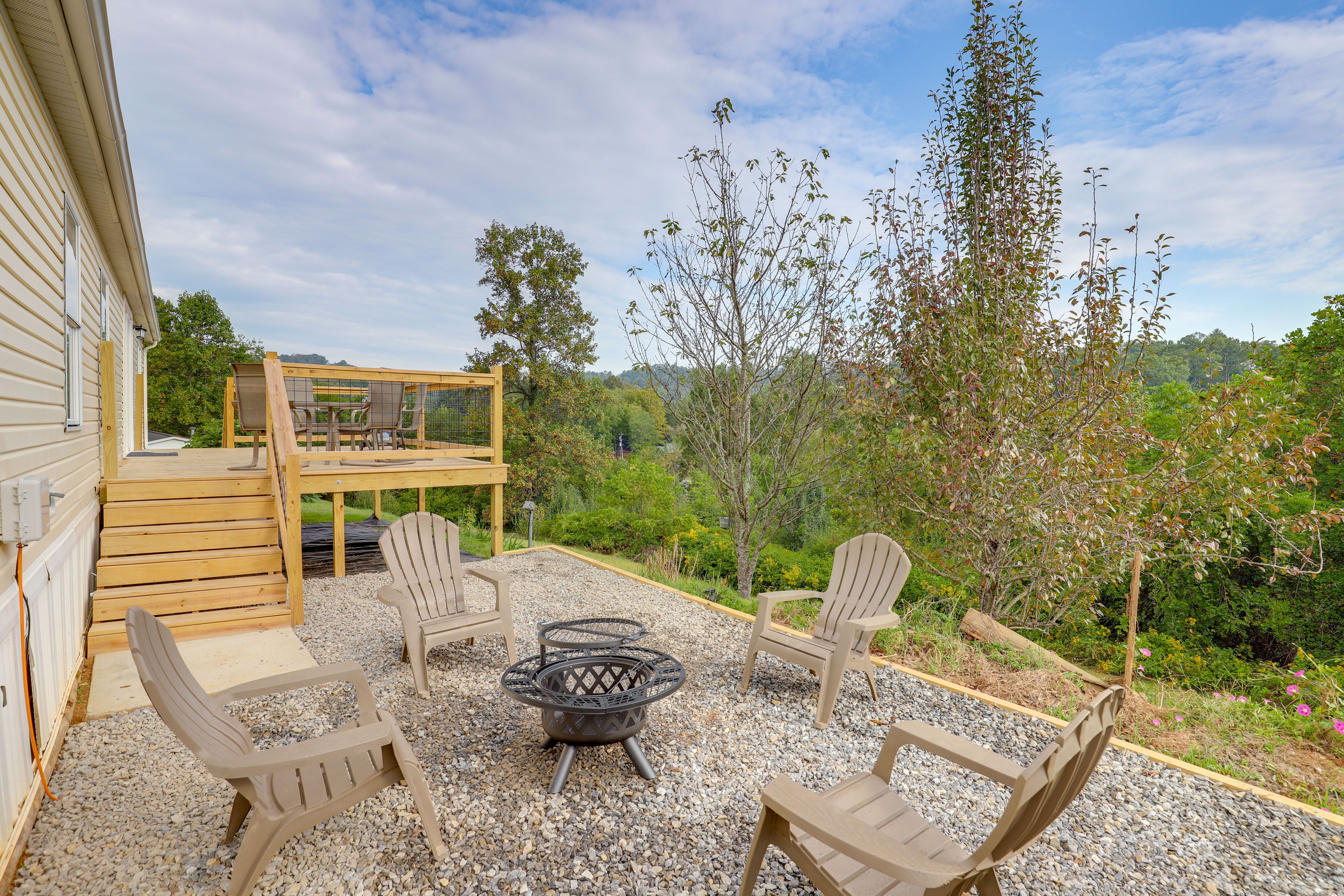 Fire Pit | Deck w/ Dining Area | Forest Views