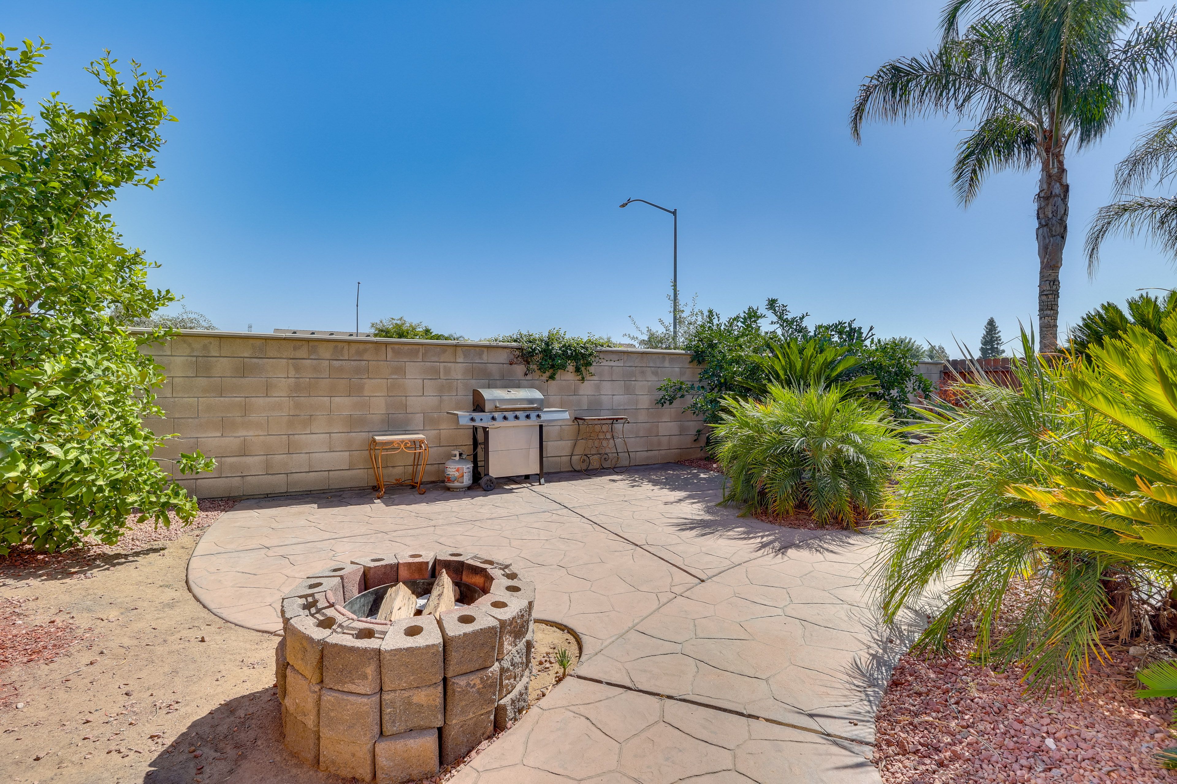 Fenced-In Yard | Dining Tables | Lounging Furniture | Wood-Burning Fire Pit