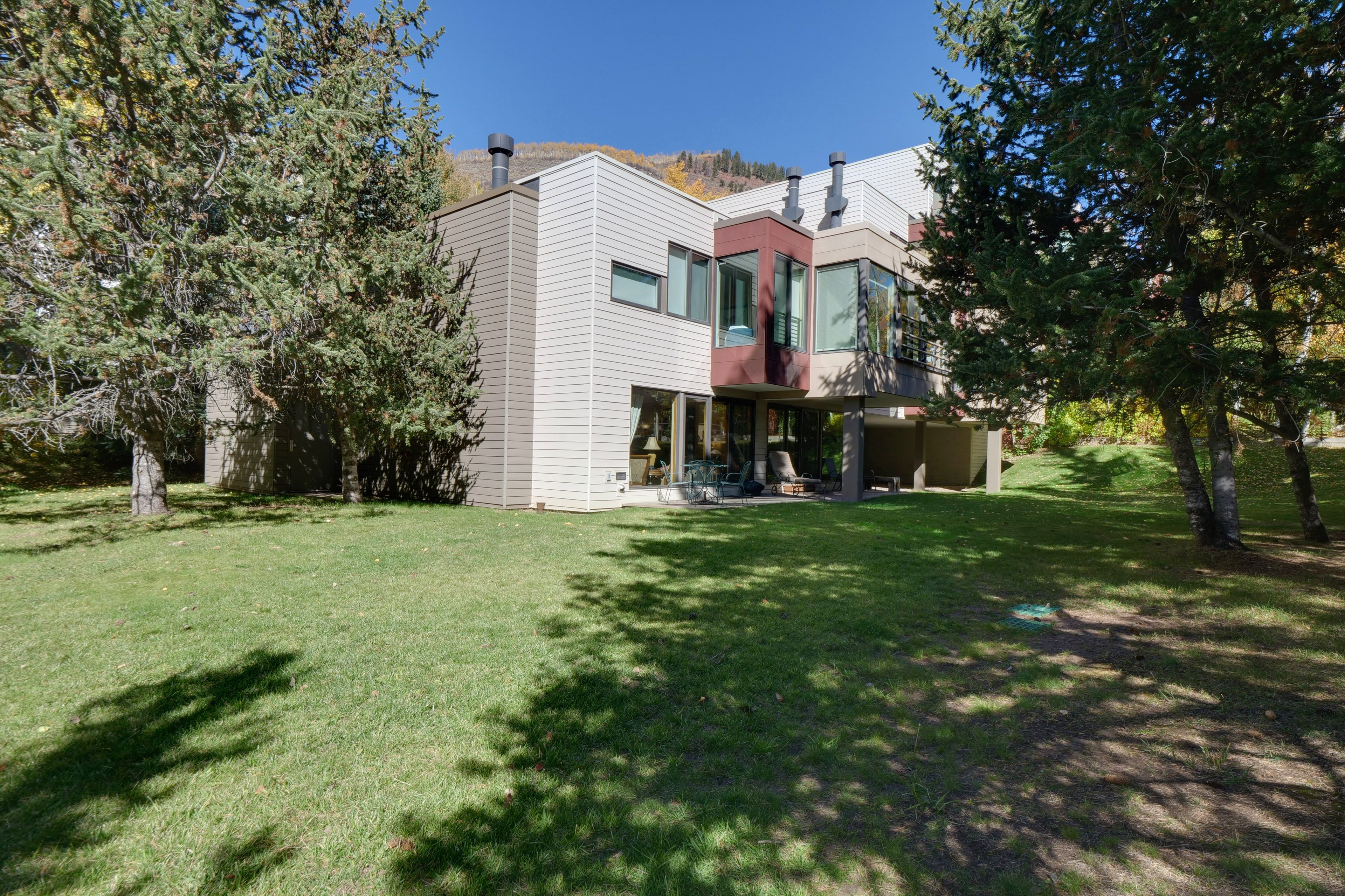 Condo Exterior | Patio w/ Dining Area | 2-Story Unit