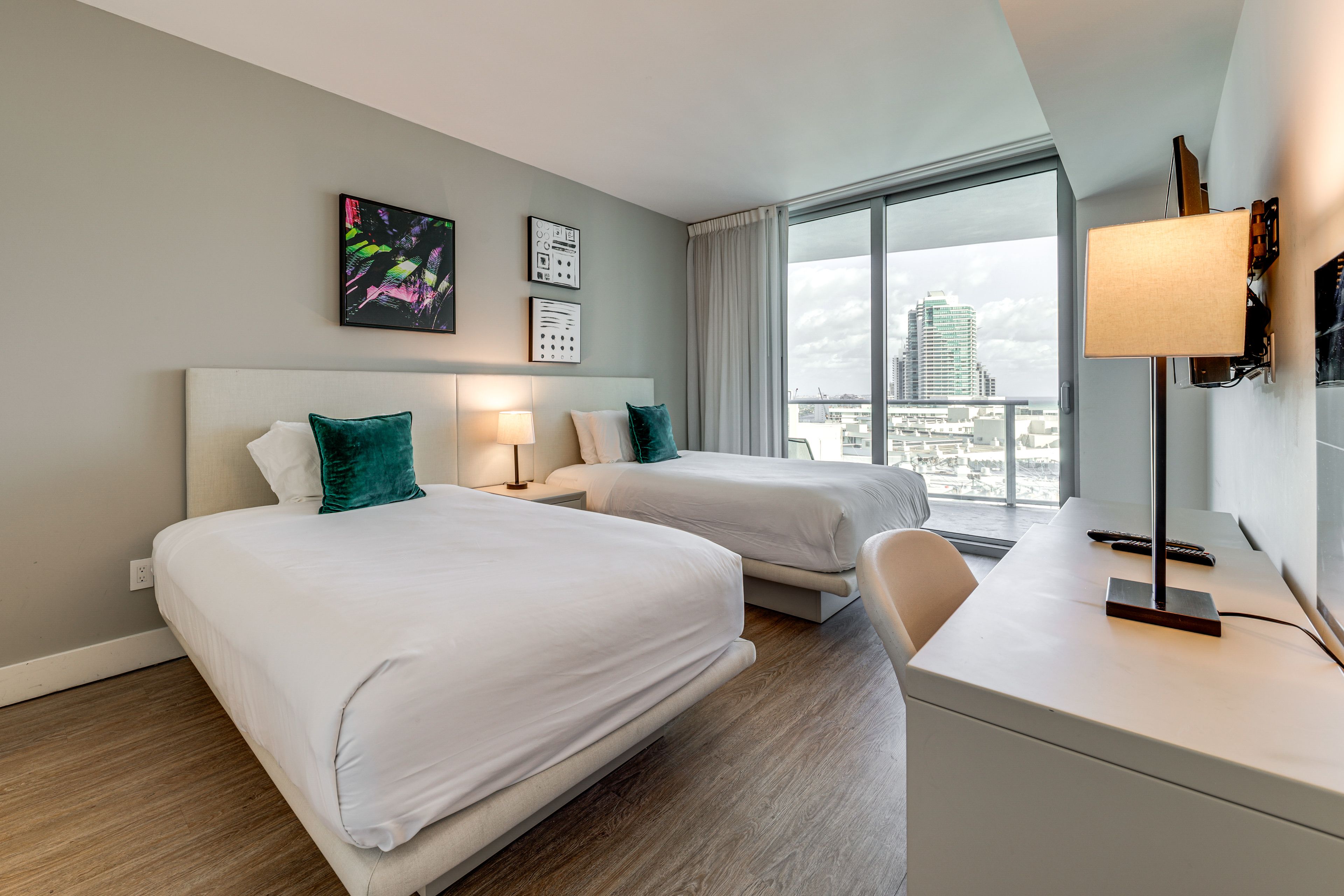 Bedroom 2 | 2 Full Beds | Laptop-Friendly Workspace | Balcony Access