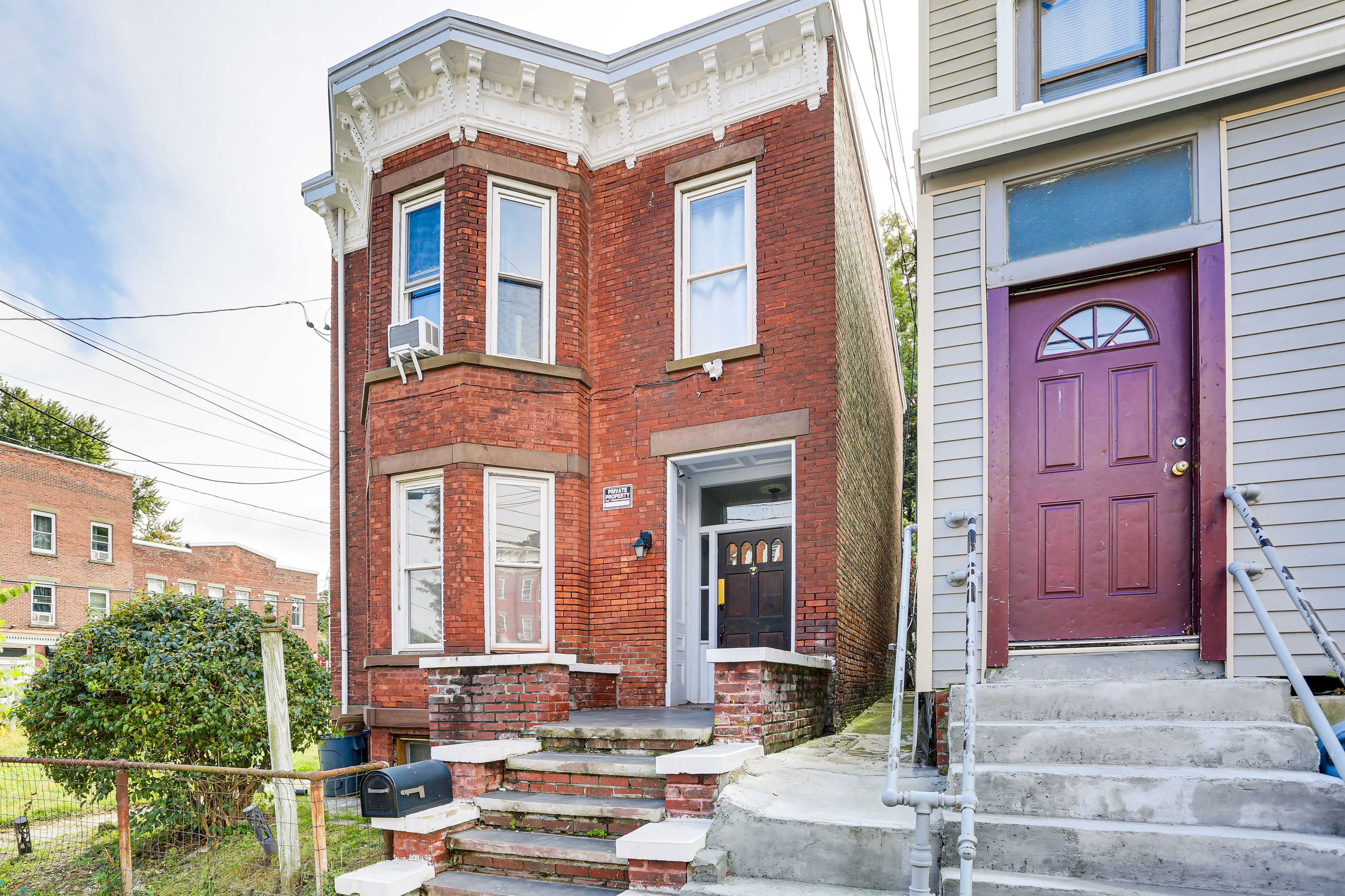 Duplex Exterior | 2nd-Floor Unit | Shared Fenced Yard