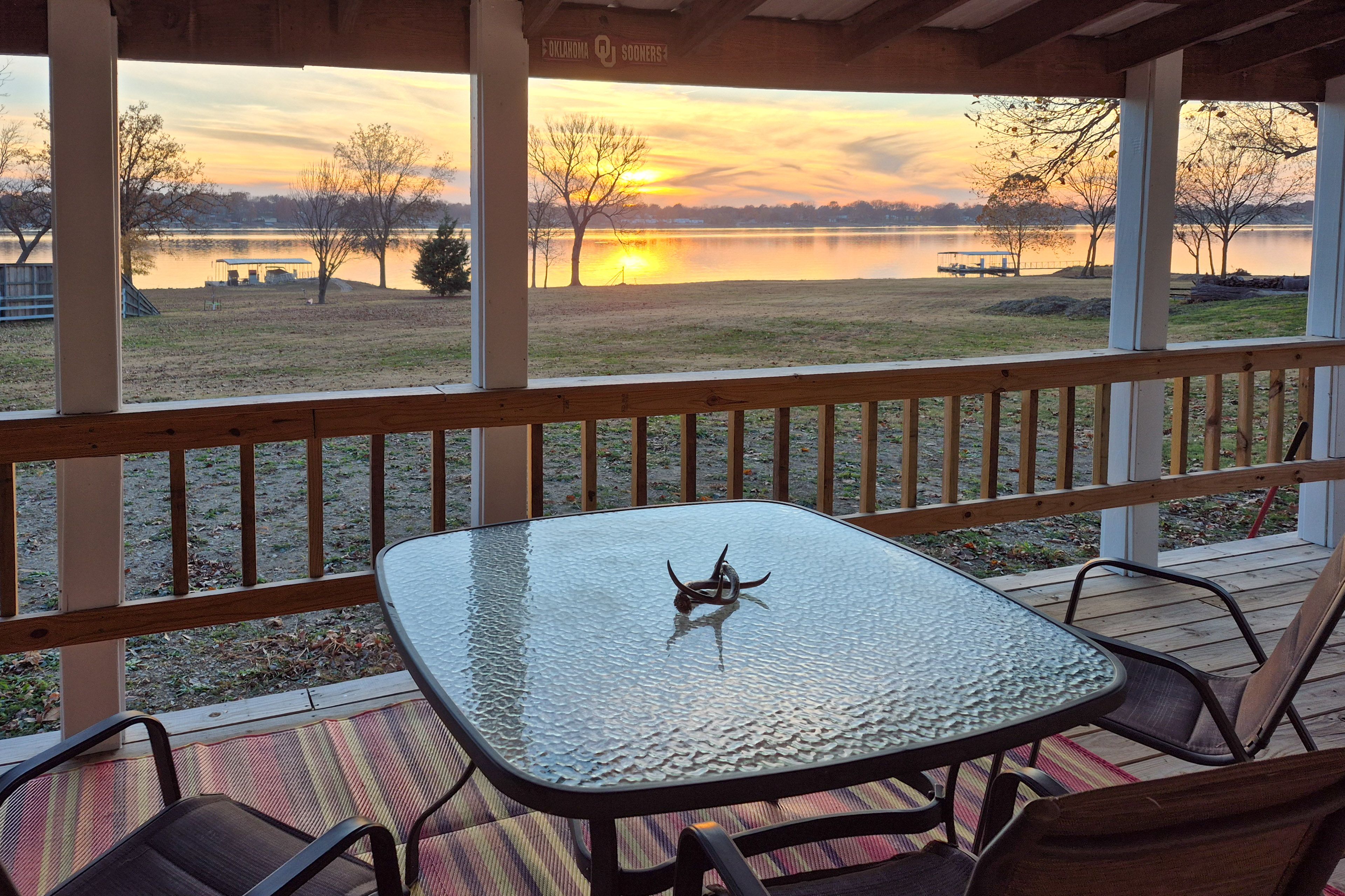 House Exterior | Covered Deck w/ Seating | Dining Area | Grill | Lake Views