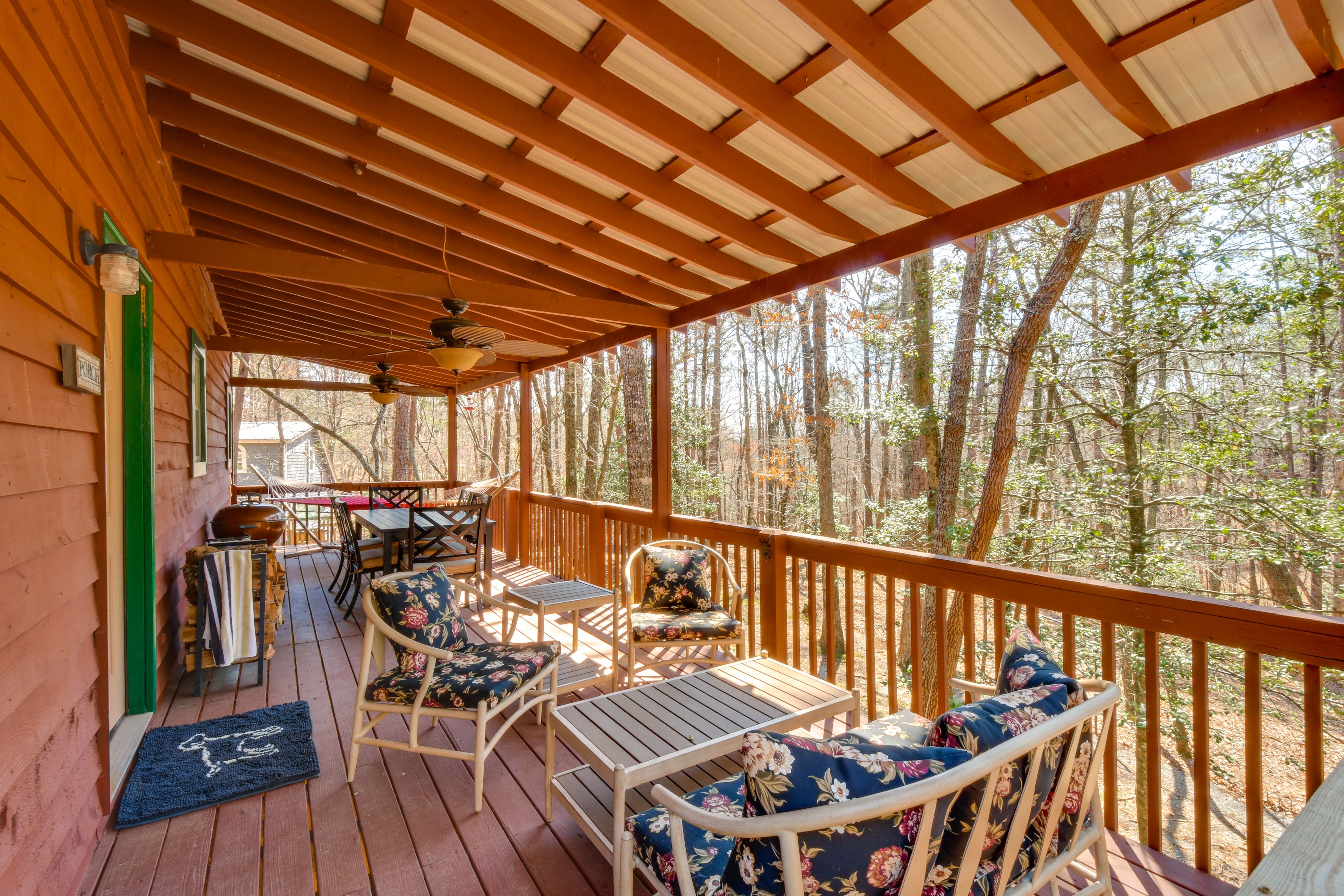 Property Exterior | Covered Deck & Porch w/ Seating | Wooded Surroundings