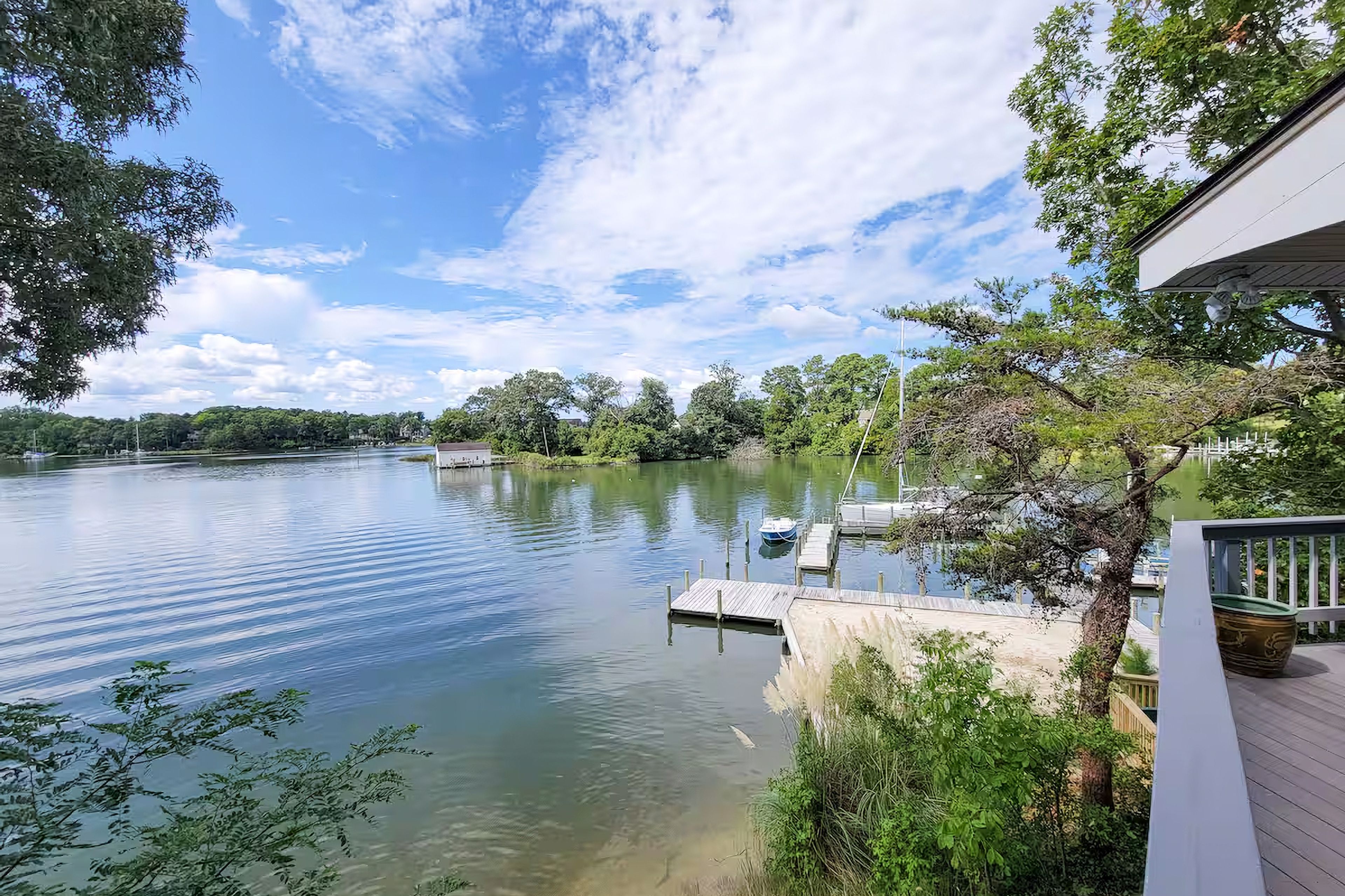 Expansive Balcony Waterfront with Beach and Dock Views
