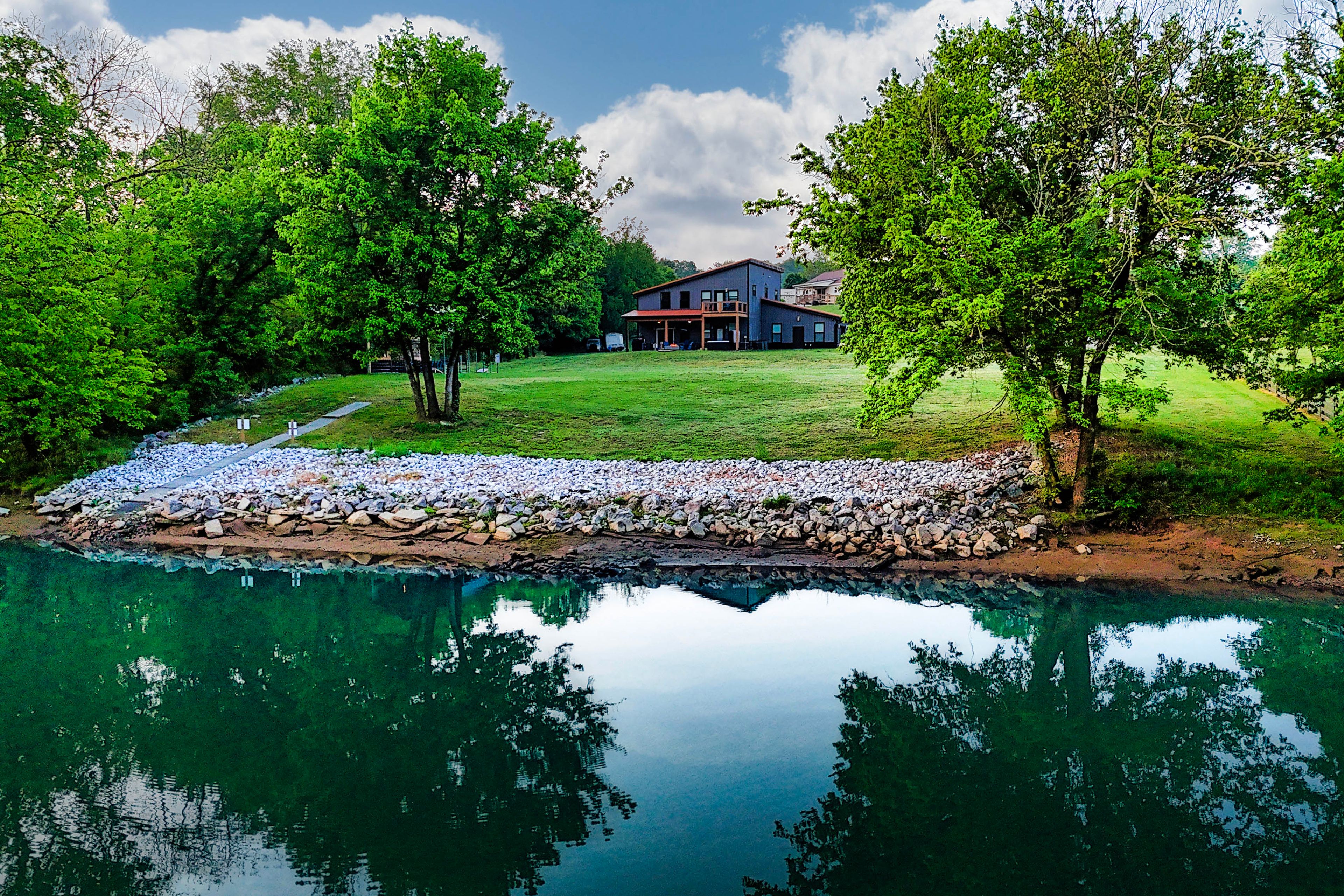 Peaceful French Broad River setting w/ room to relax on level 1-acre property