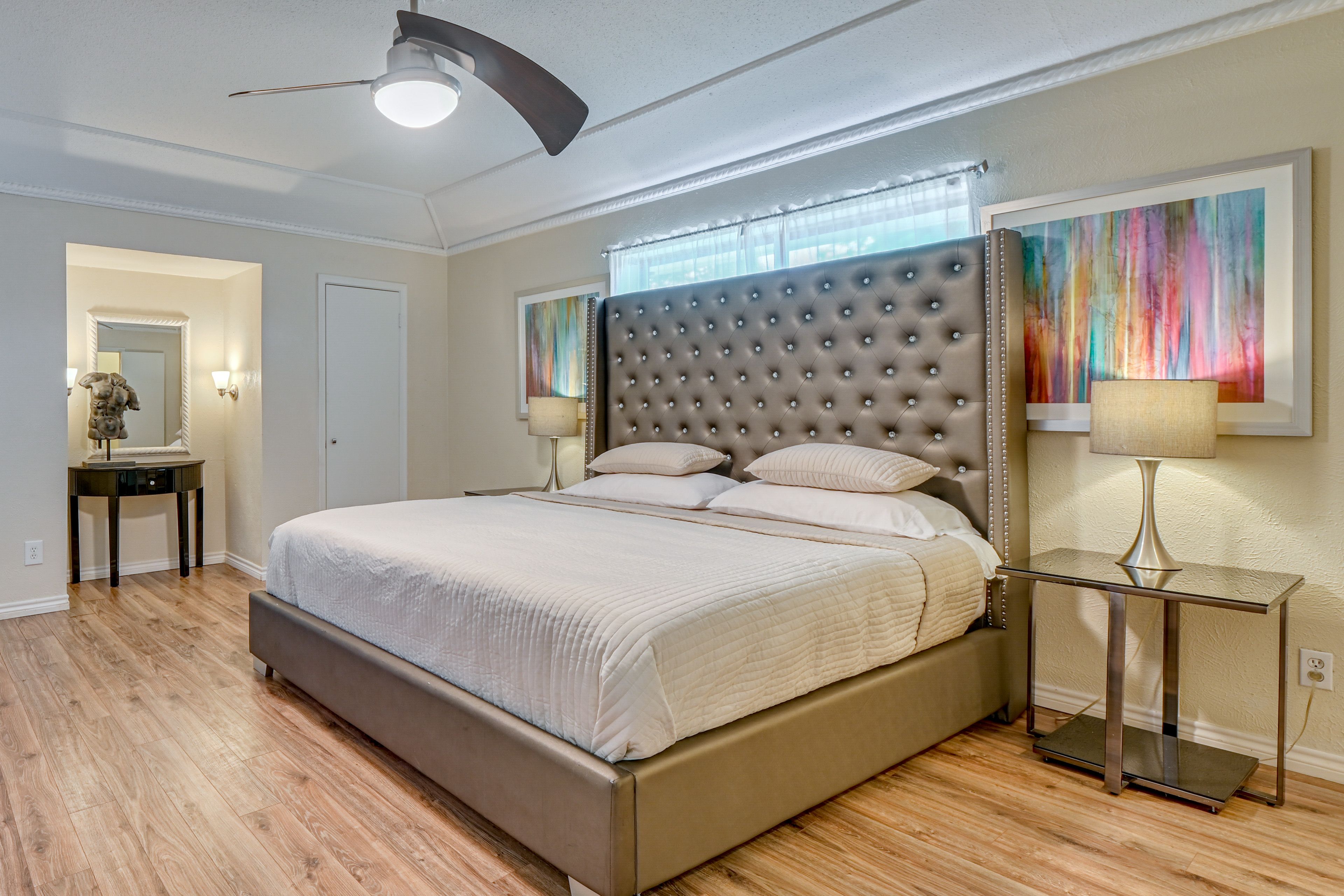 Primary/Main bedroom with King sized bed, modern art surrounding