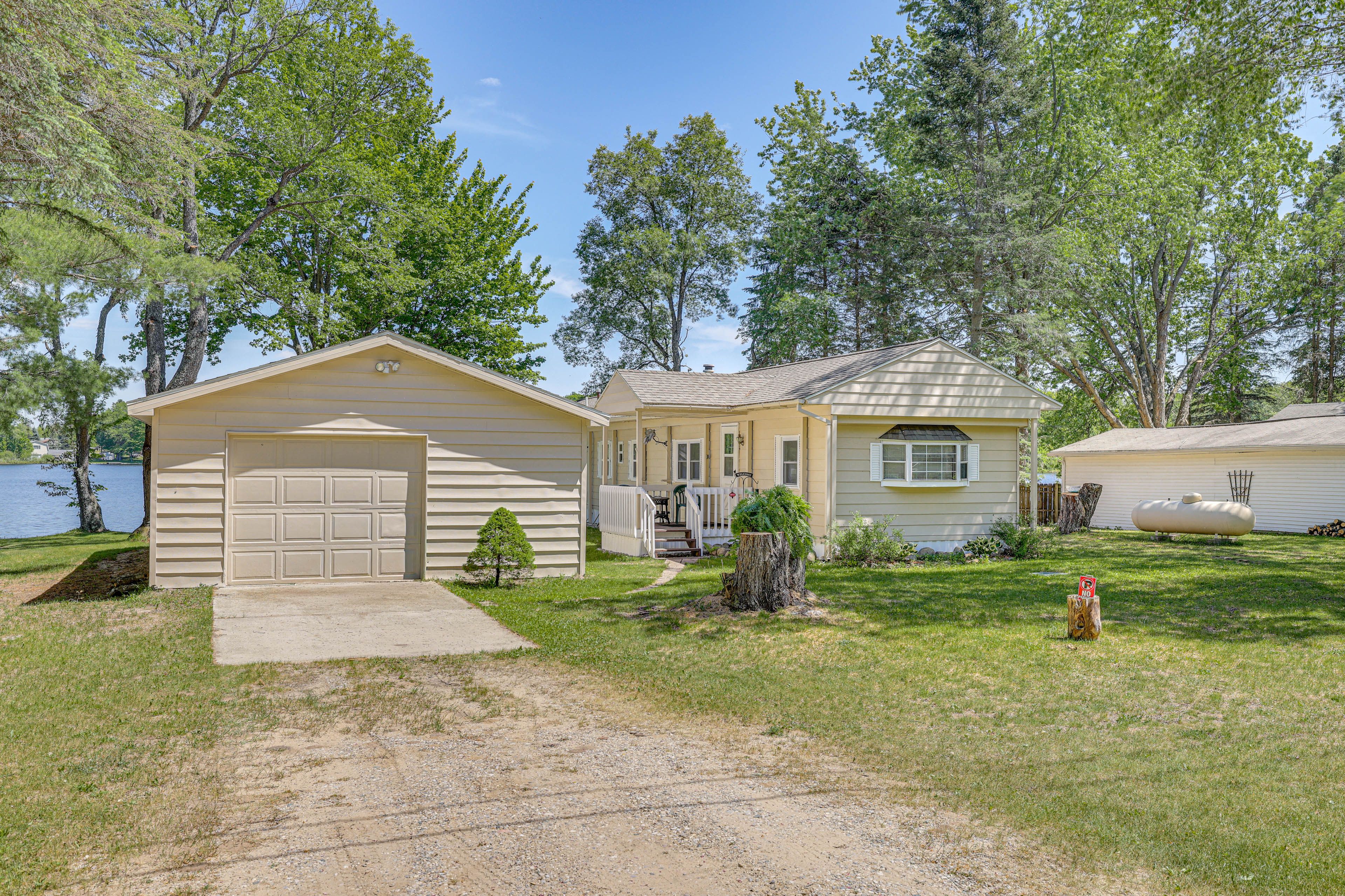 Property Exterior | Spacious Yard w/ Dining Table | Fire Pit | Kayaks