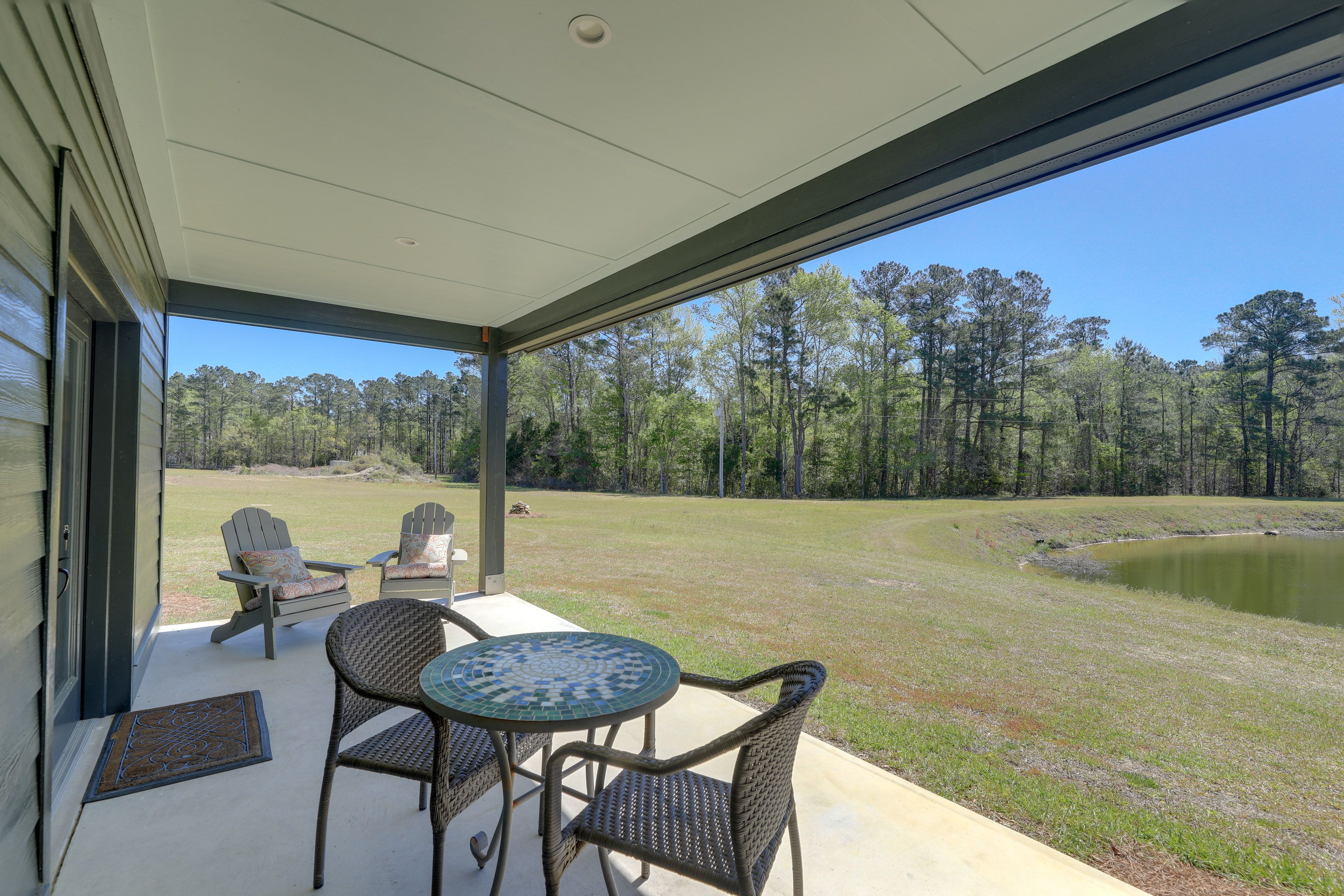 Covered Patio | Outdoor Shower | Dining Area | Pond & Forest Views