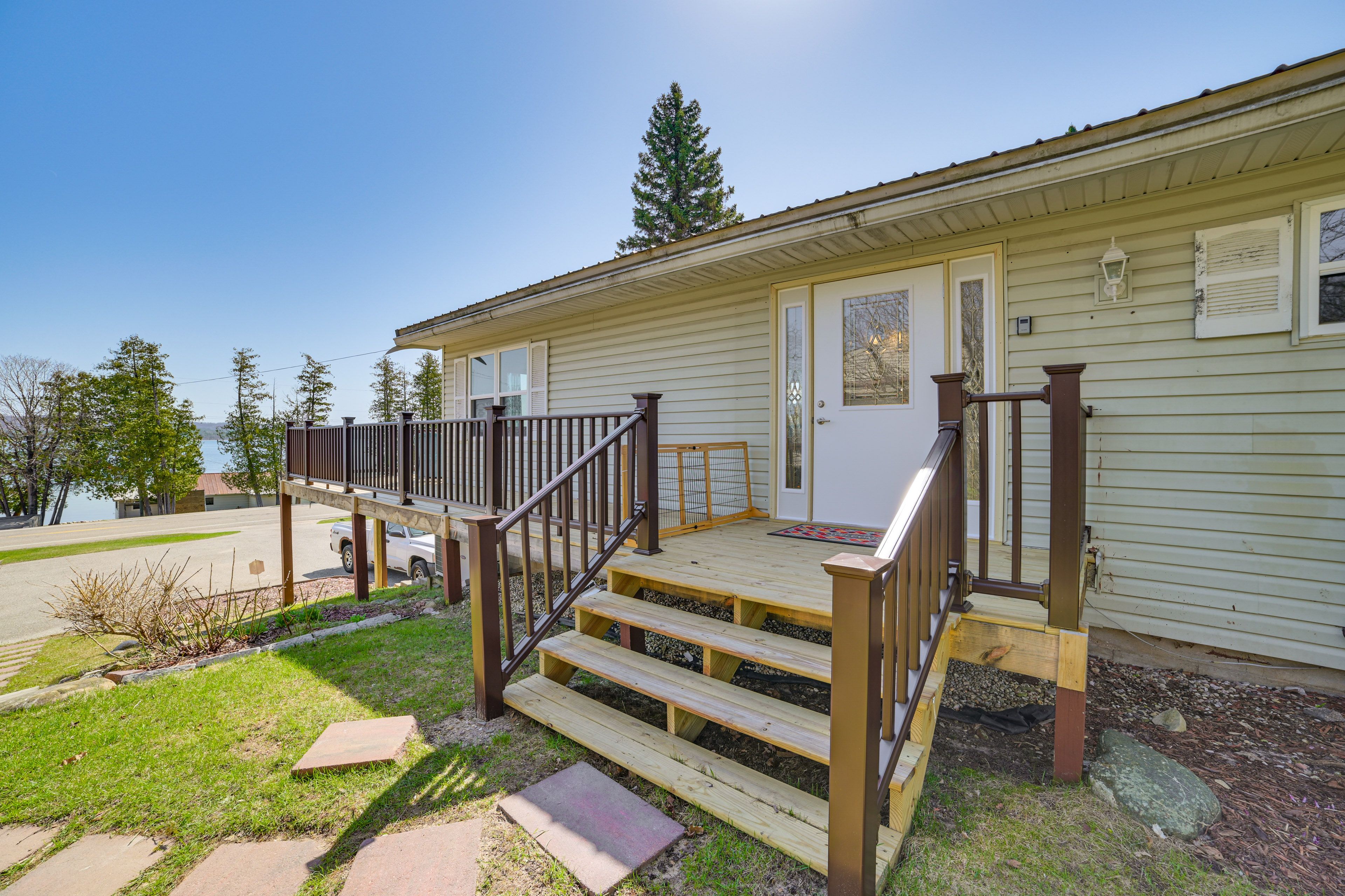 Property Entrance | Deck w/ Seating & Dining Table | Lake Views