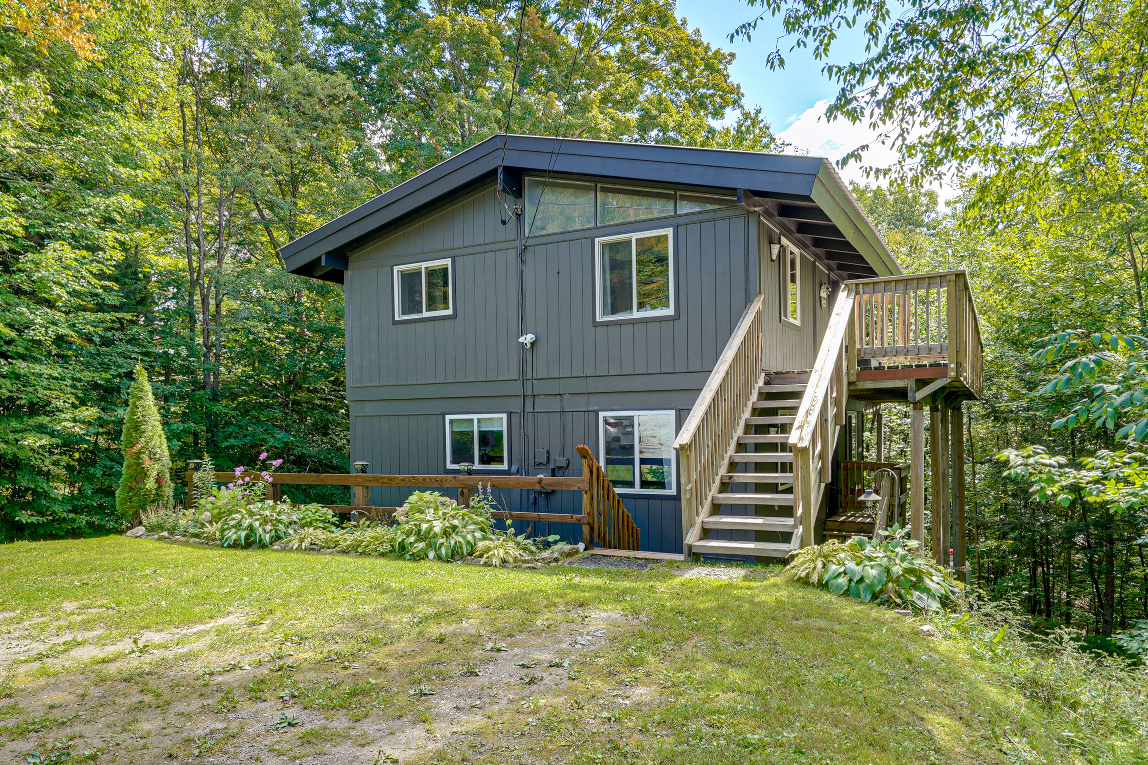 Property Exterior | Furnished Deck | Serene, Tree-Filled Surroundings